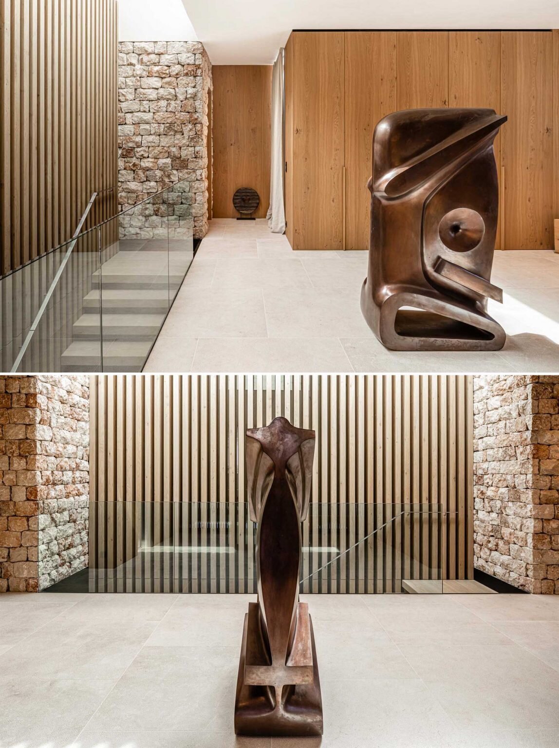 This Mallorca home features a sculptural entrance hall with a bronze statue, warm wood details, and textured stone walls.