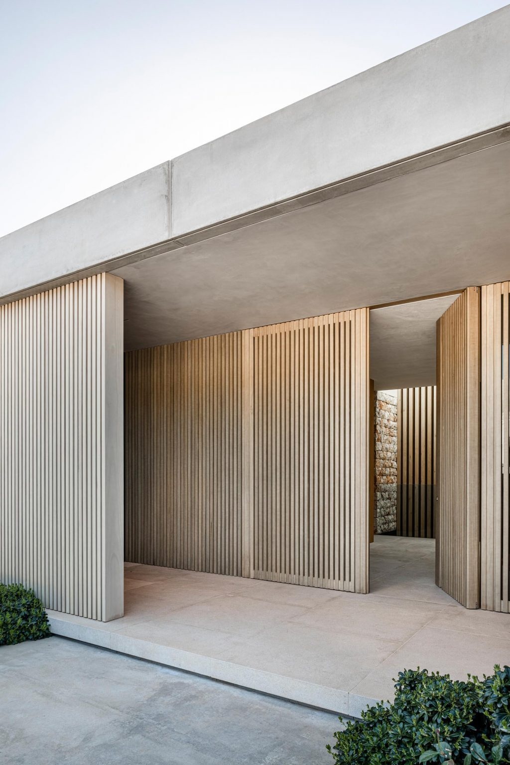 Traditional “Pedra en sec” stone wallsand wood slat elements give this Mallorca home a timeless Mediterranean look while naturally helping regulate temperature year-round.