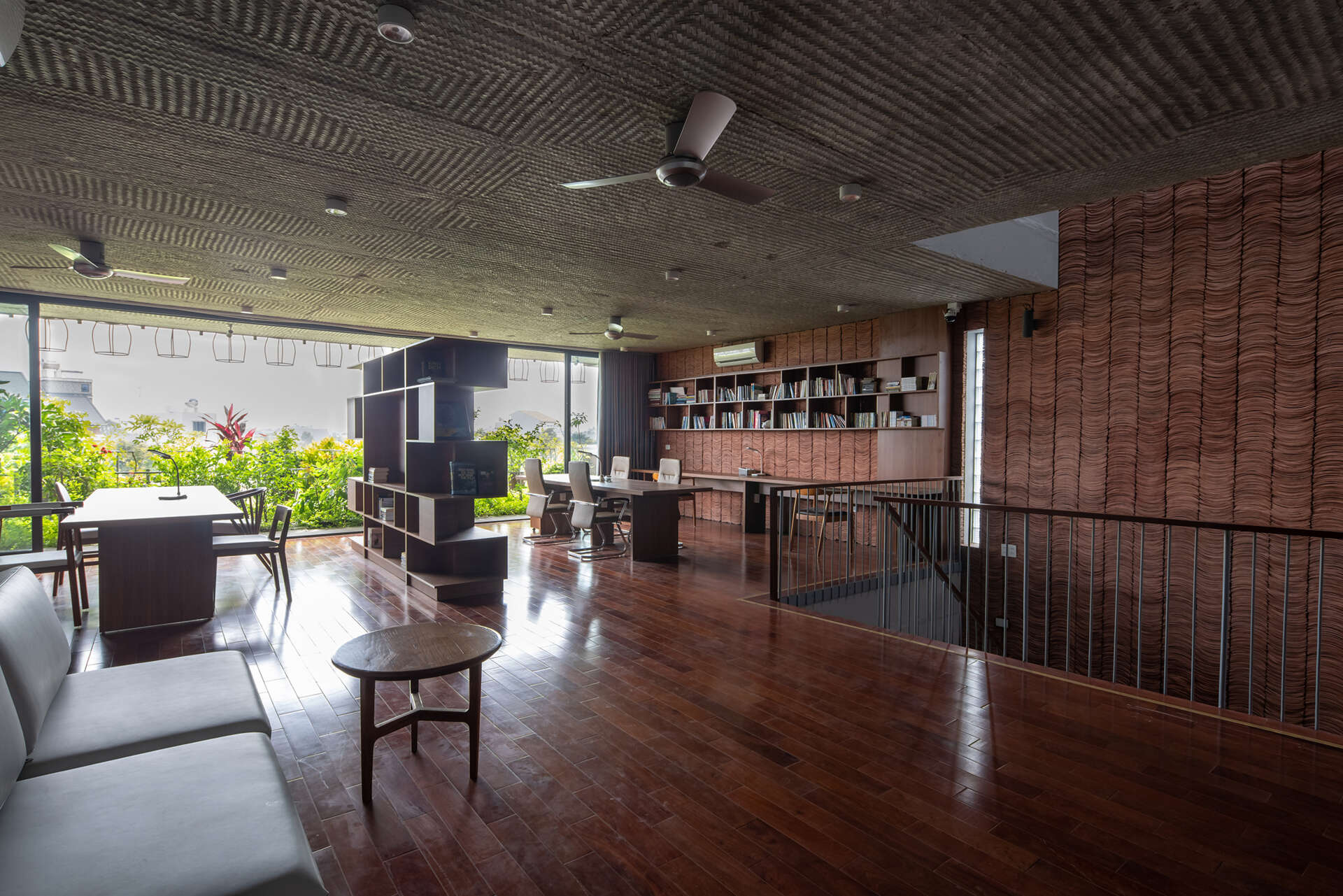 Concrete interiors are balanced with wood furniture, creating simple and adaptable living areas.