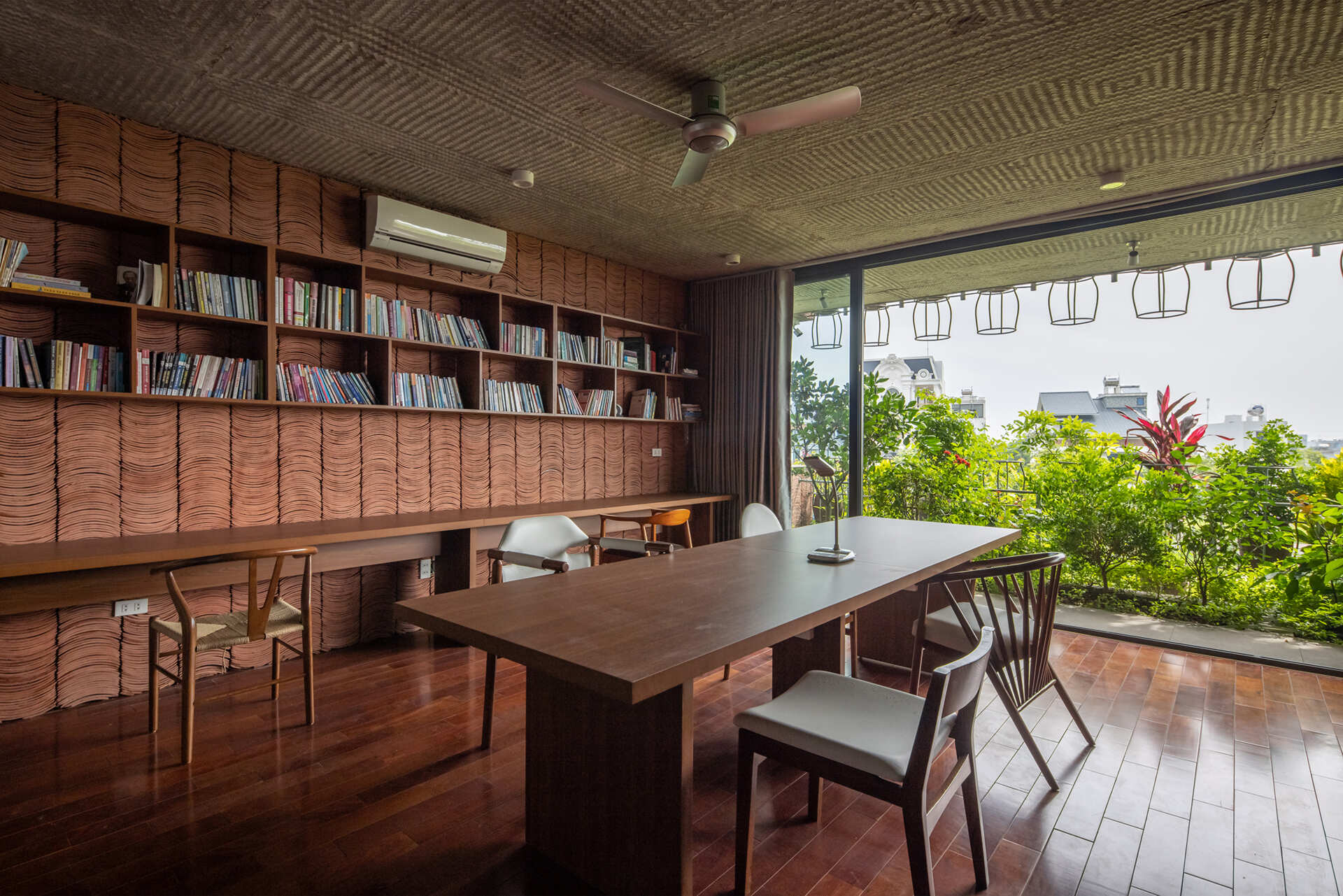 Concrete interiors are balanced with wood furniture, creating simple and adaptable living areas.