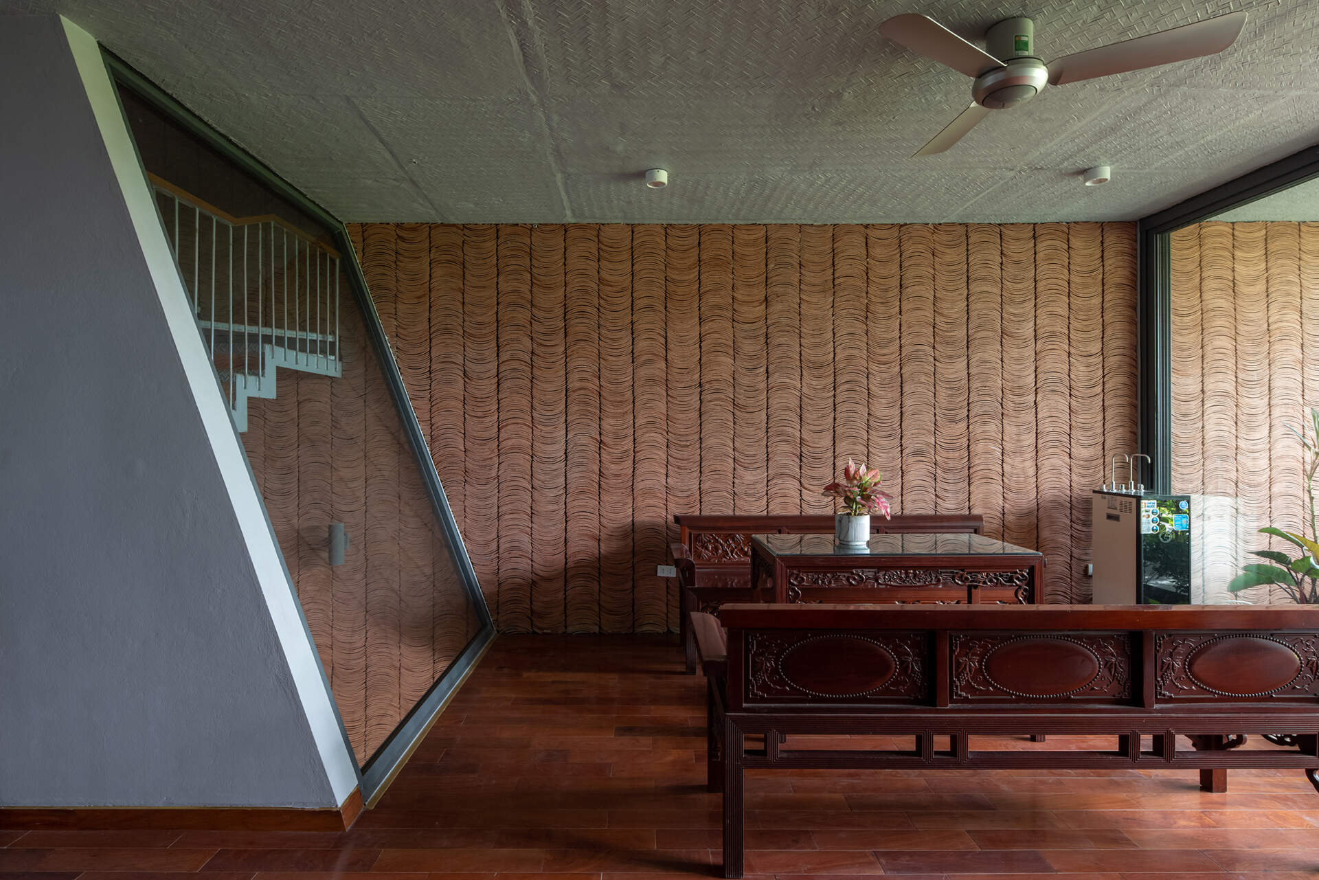 Concrete interiors are balanced with wood furniture, creating simple and adaptable living areas.