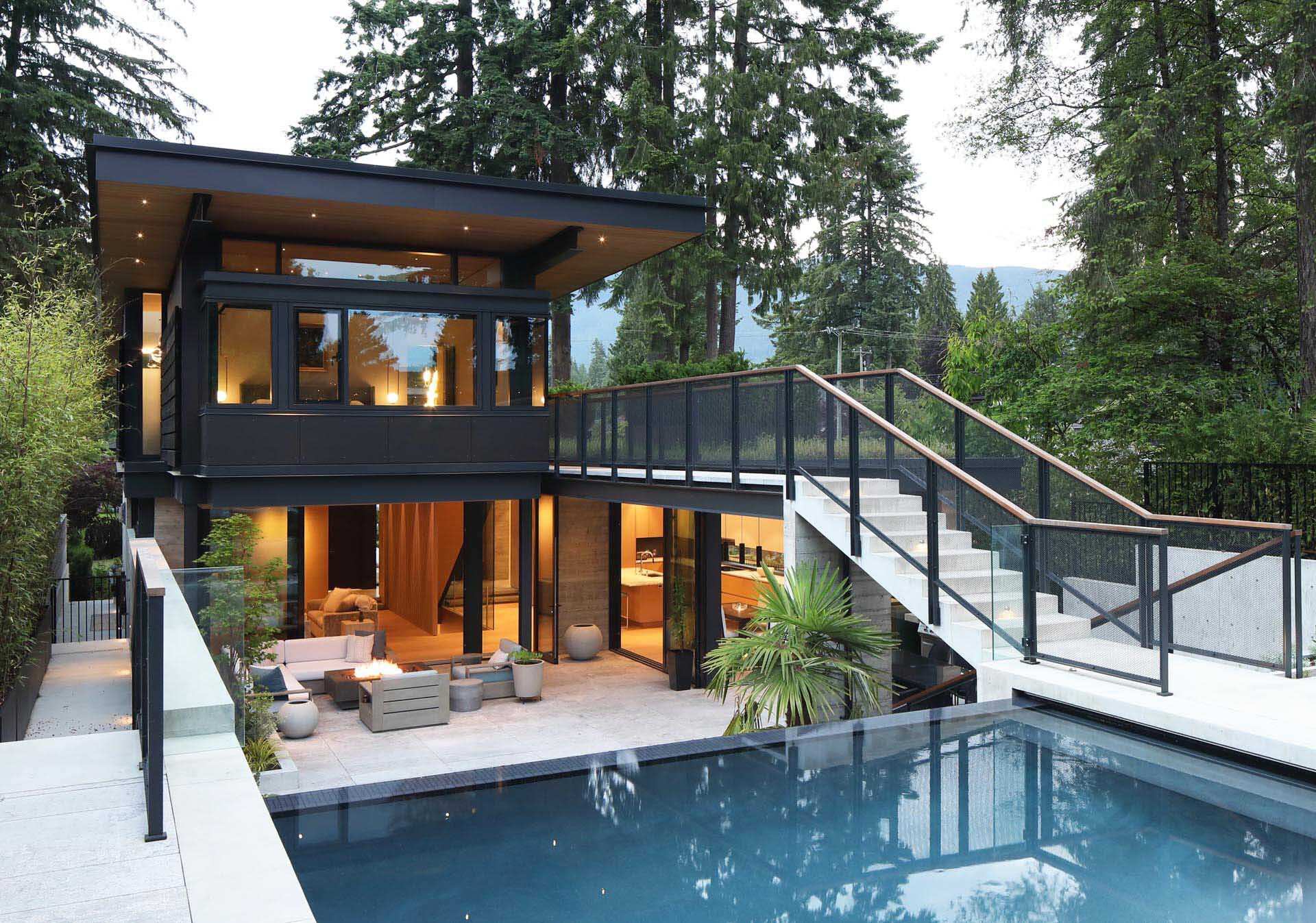 A dramatic elevated bridge connects the backyard to this modern North Vancouver home while shaping the entire architectural design.