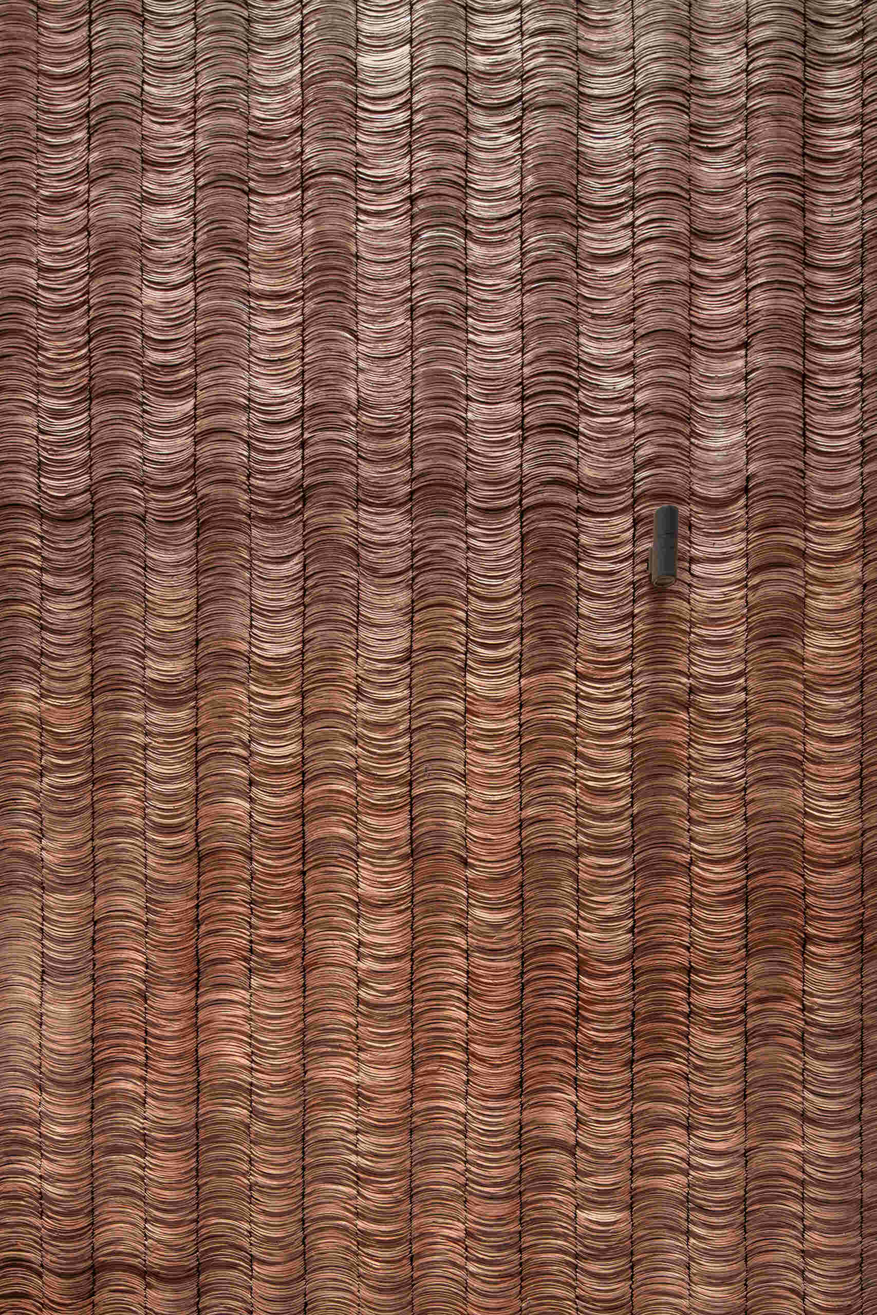 Traditional yin yang tiles and ceramic materials link the house to familiar building techniques.