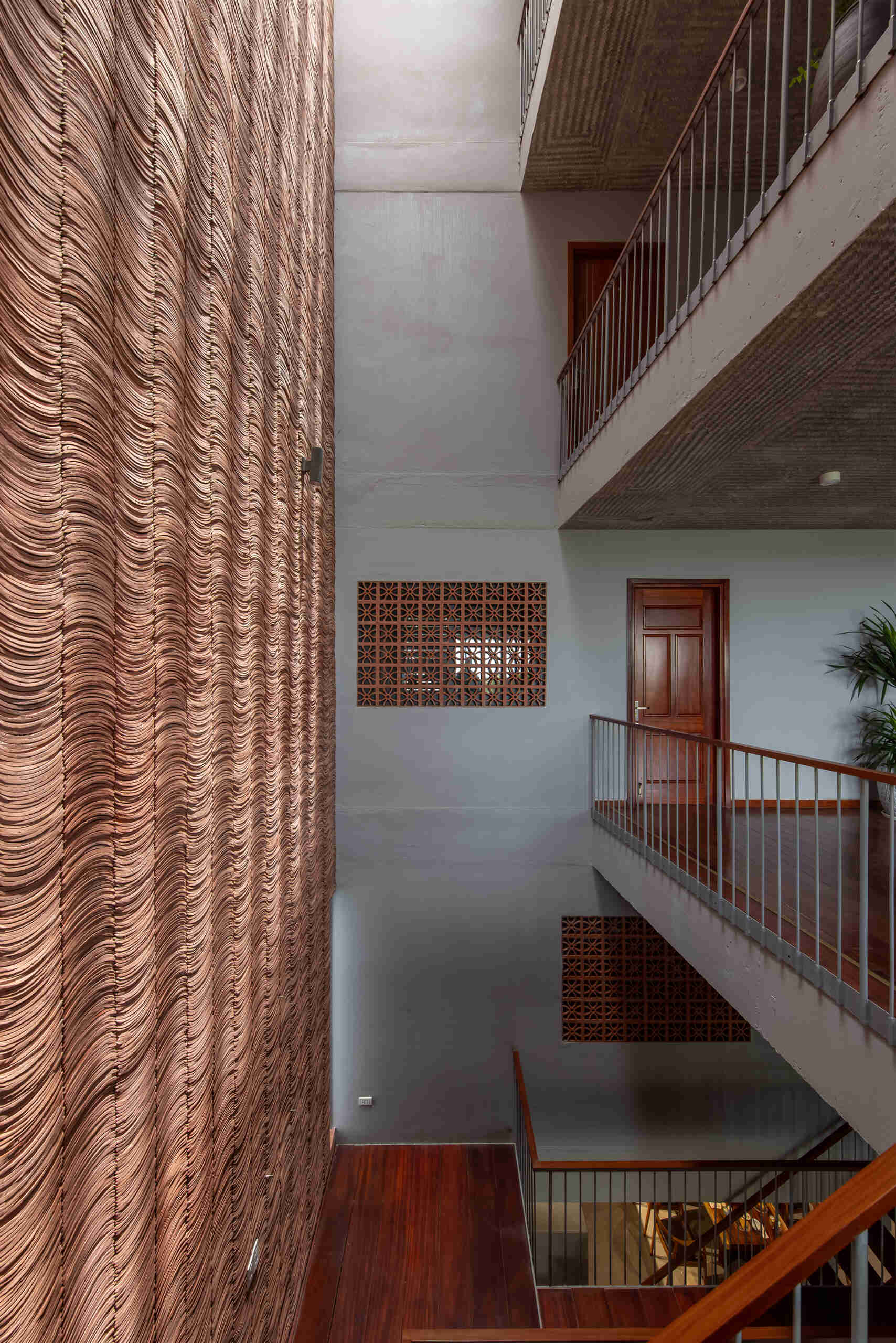 Traditional yin yang tiles and ceramic materials link the house to familiar building techniques.