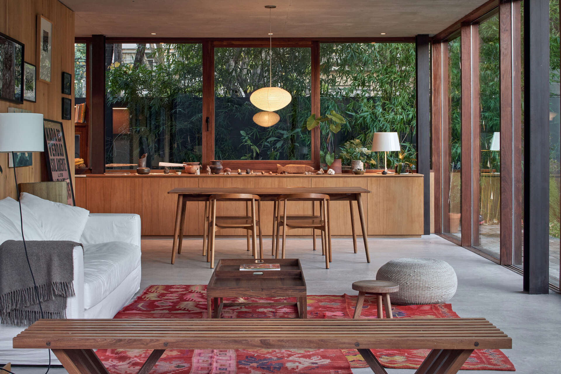 An open living and dining area flows straight into a brick patio, with sliding glass doors creating a seamless indoor-outdoor space.