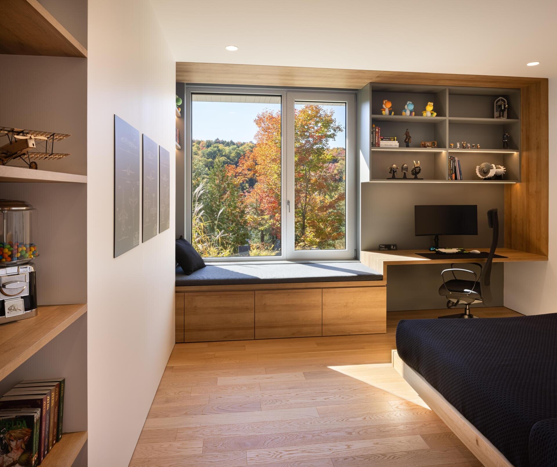 Warm wood finishes, built-in desks, and large windows give these kids’ bedrooms a calm and modern atmosphere.