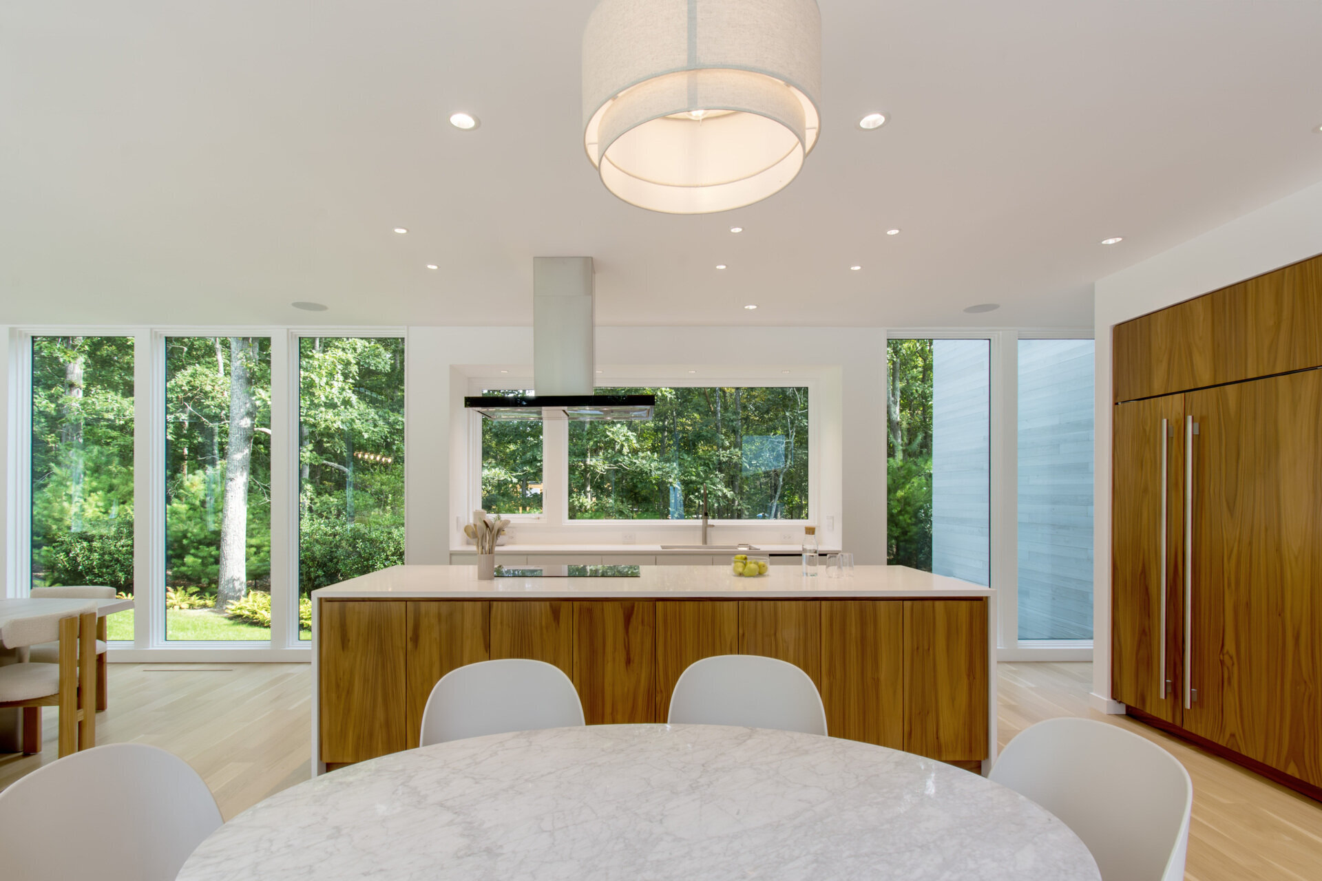 Warm wood tones and modern cabinetry bring a clean yet inviting atmosphere to this light-filled kitchen.
