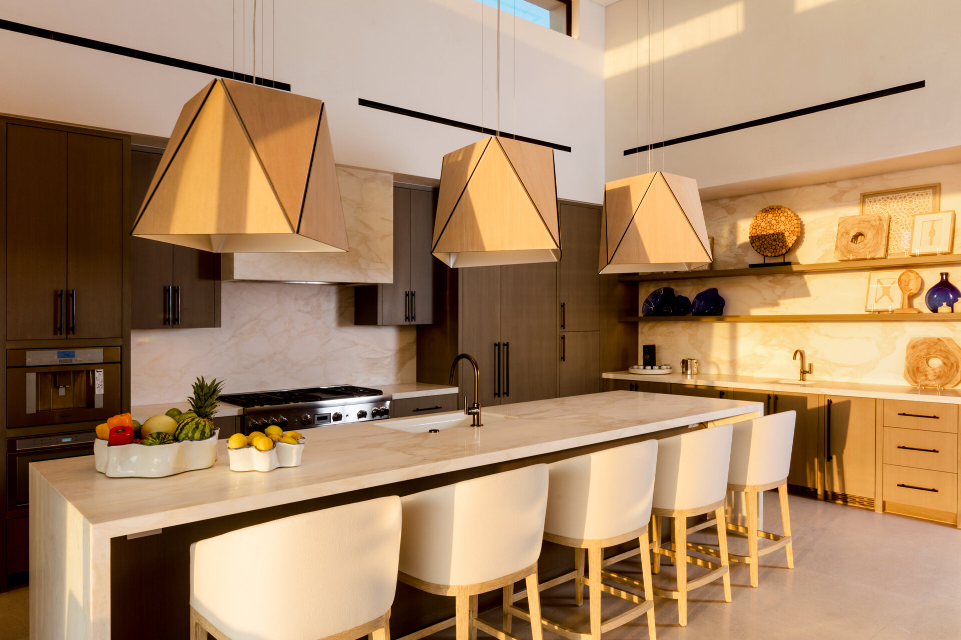 Warm woods, sculptural Cerno Calx pendants, and layered textures give this luxury Cabo kitchen a relaxed but elevated atmosphere.