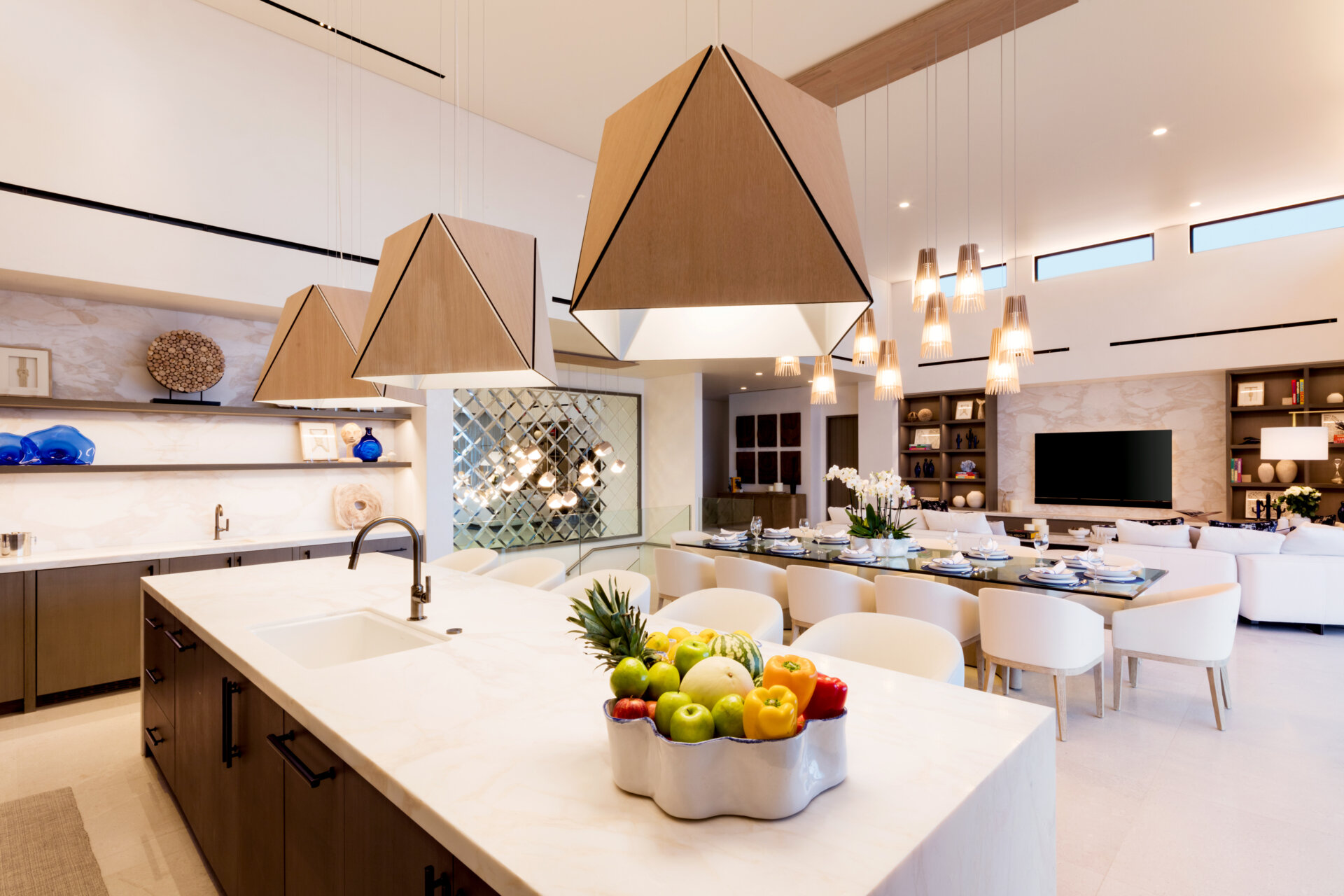 Warm woods, sculptural Cerno Calx pendants, and layered textures give this luxury Cabo kitchen a relaxed but elevated atmosphere.