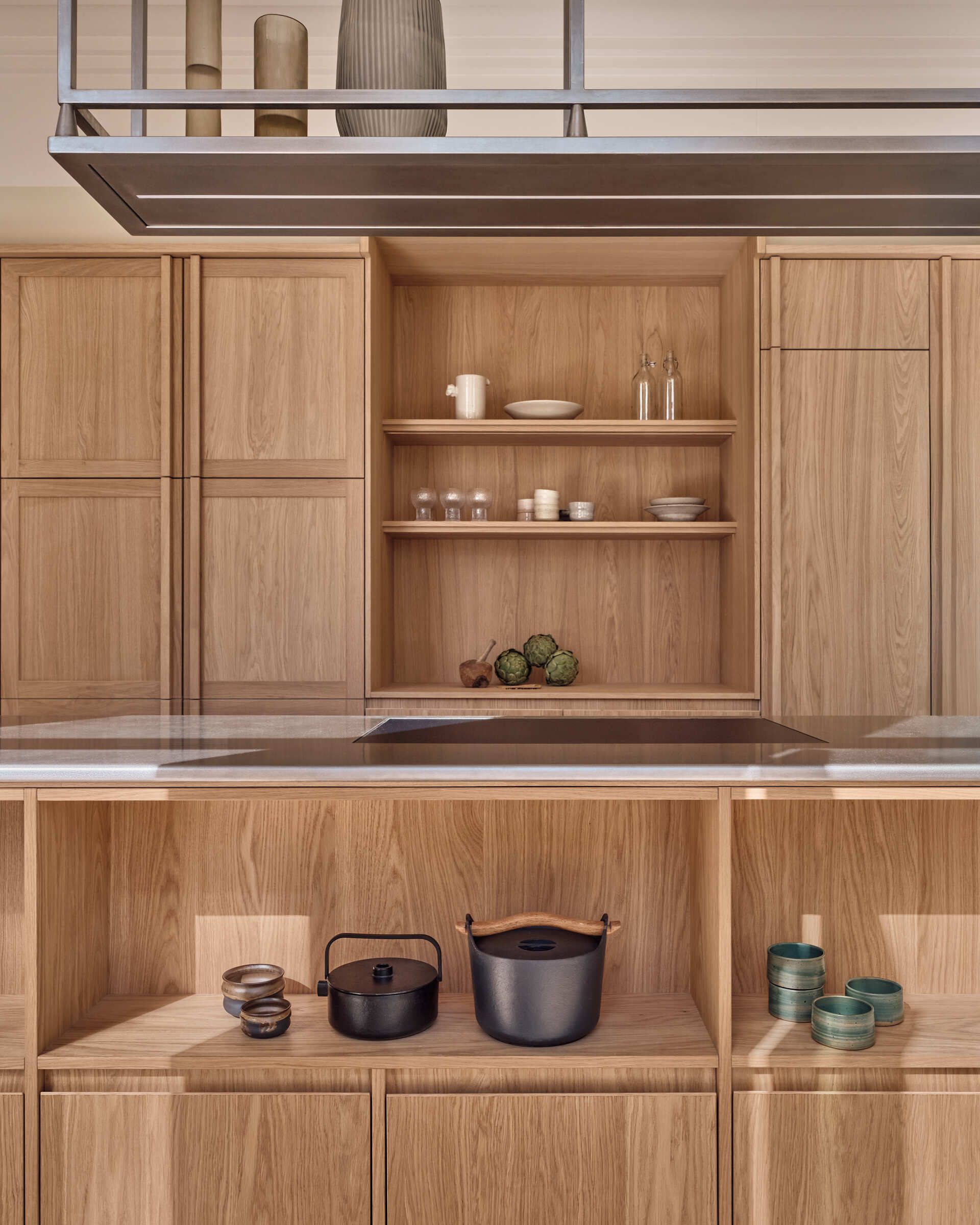 Warm wood cabinetry, textured glass, and stainless steel surfaces give this kitchen a perfect mix of comfort and modern edge.