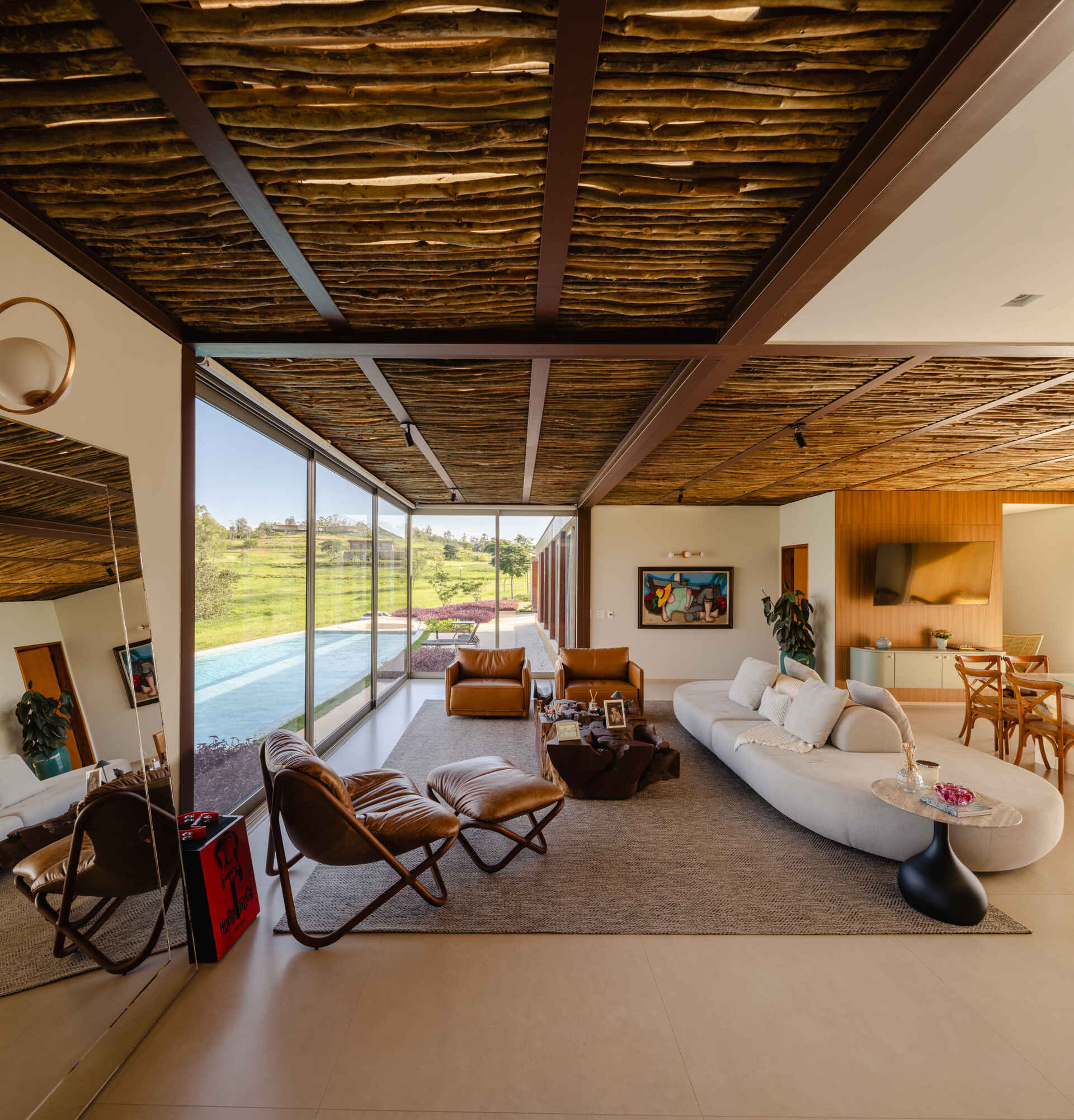 Floor-to-ceiling glass, open-plan interiors, and a floating cantilevered living room make the social spaces inside Casa Themis feel bright, modern, and connected to nature.