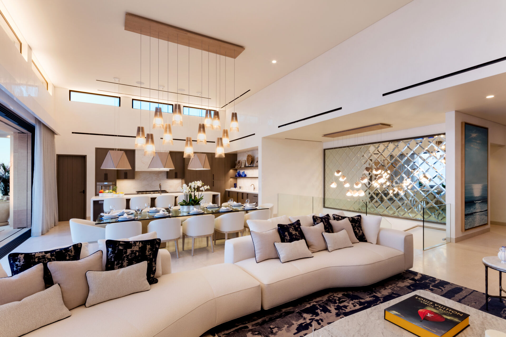 The living room in this Los Cabos condo combines ocean views, layered woods, and relaxed seating designed for family gatherings.