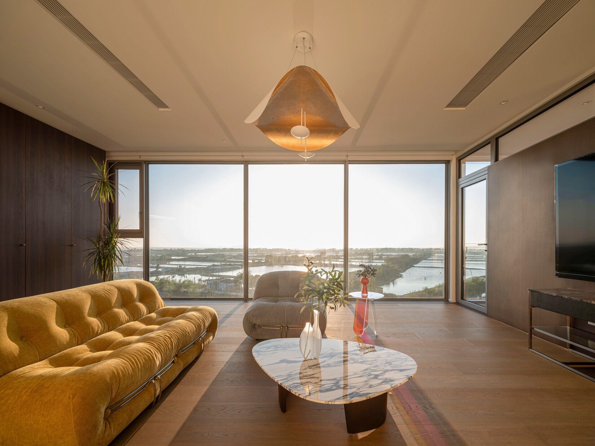 Coastal Villa Residence in Raoping, China by VALUE WORKS ARCHITECTS rethinks rural family living with split-level interiors, sea views and modern multi-generational design on a compact coastal site.
