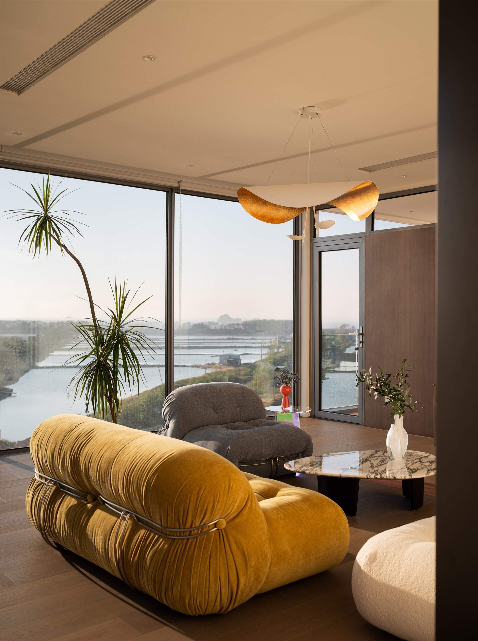 Positioned at the top of the house, this lounge and deck captures coastal views while creating a quiet shared space for parents and children.