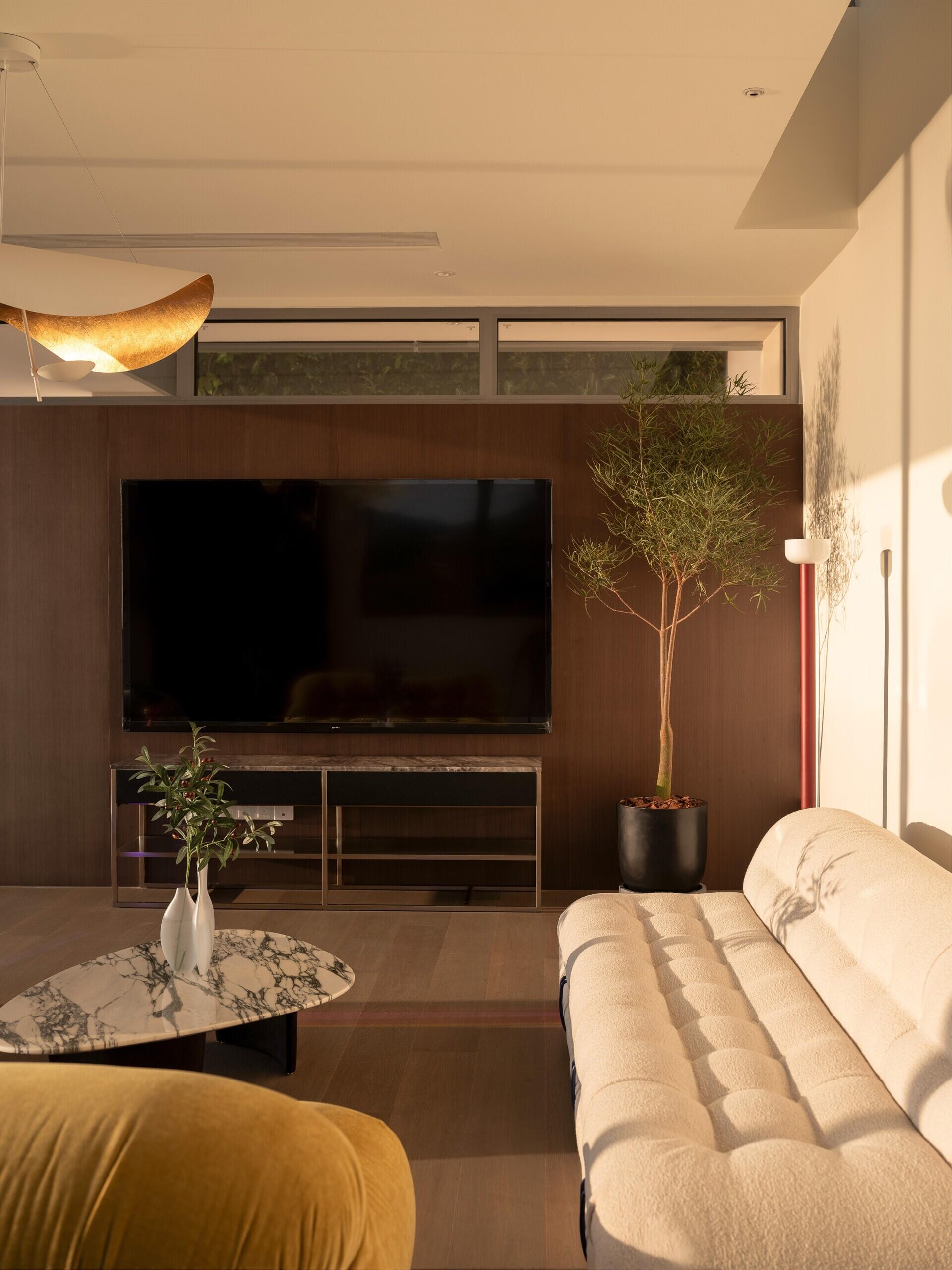 Positioned at the top of the house, this lounge and deck captures coastal views while creating a quiet shared space for parents and children.