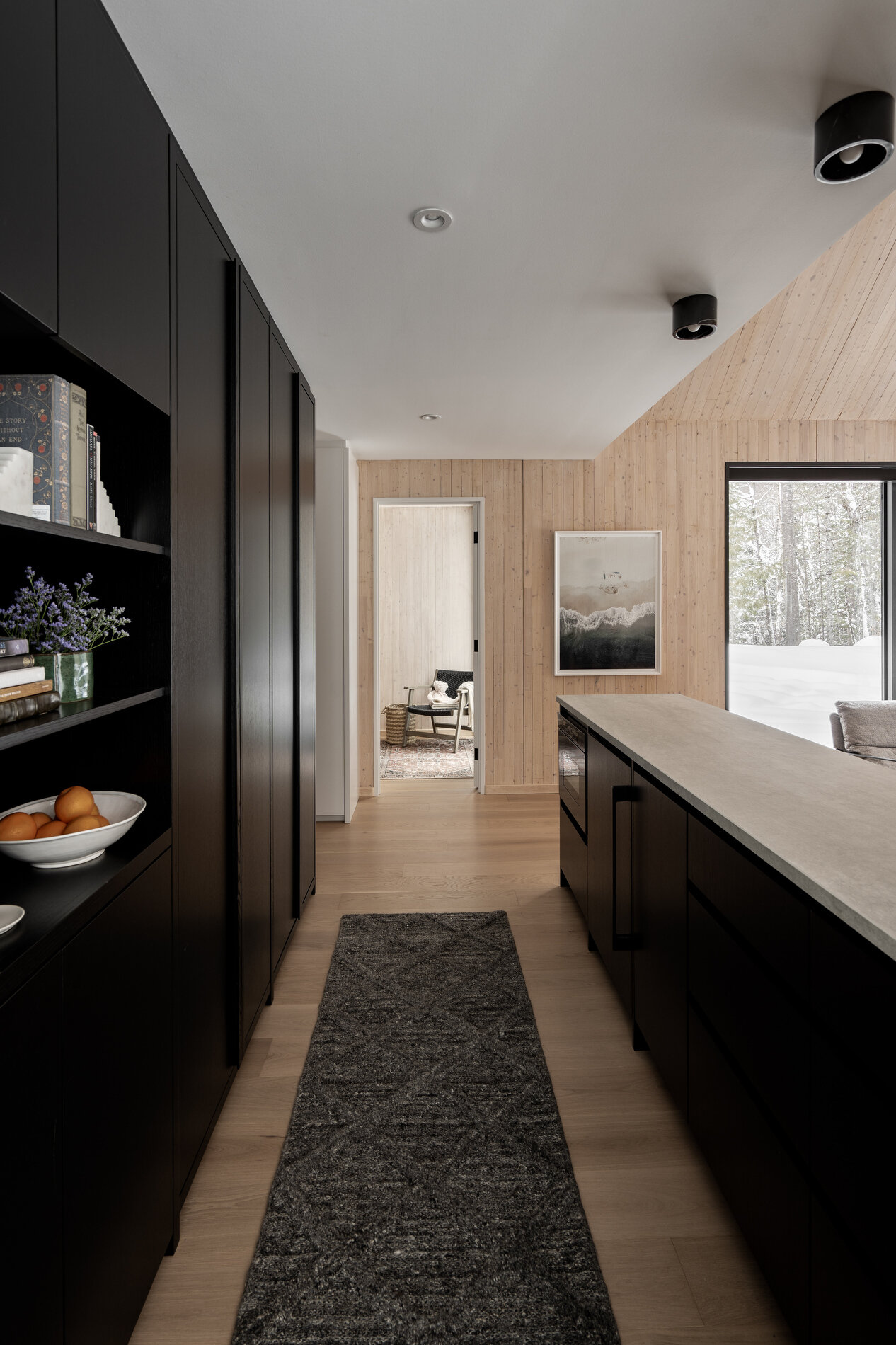A modern kitchenette with black cabinets.