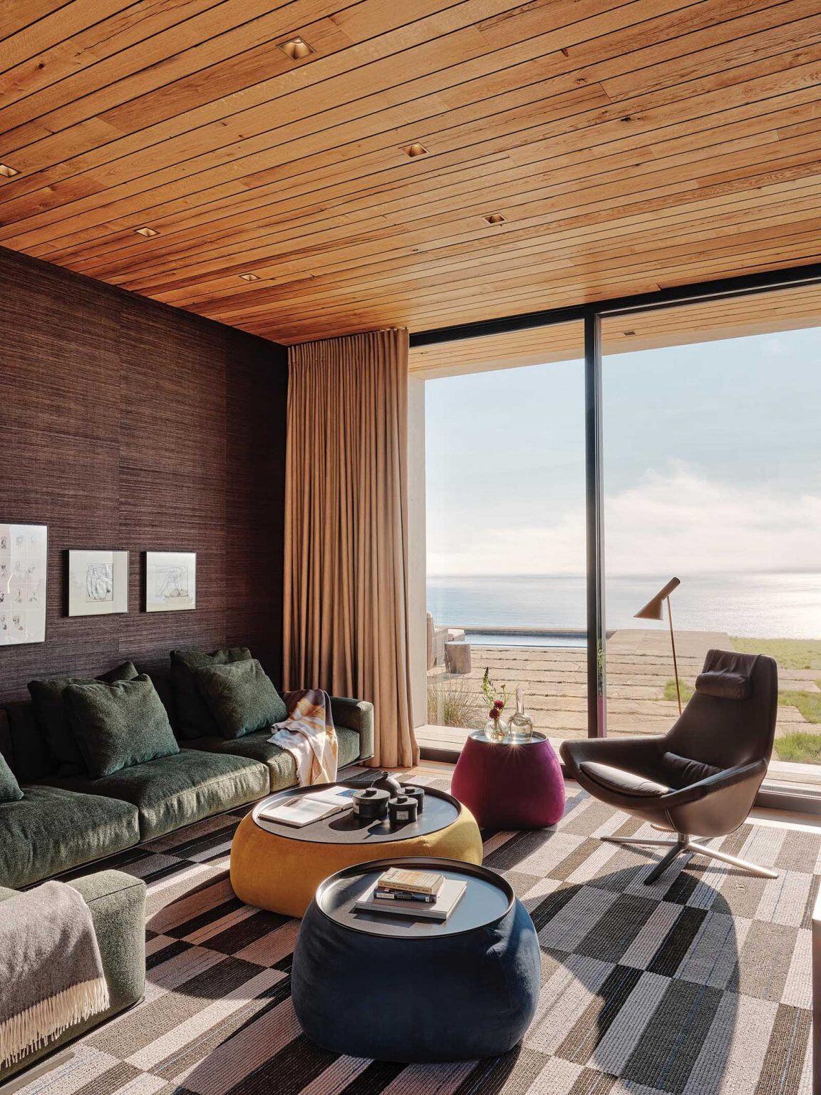 Wood ceilings, Venetian plaster walls, and colorful mosaic accents warm up the bright open-plan interiors of this modern Big Sur home.