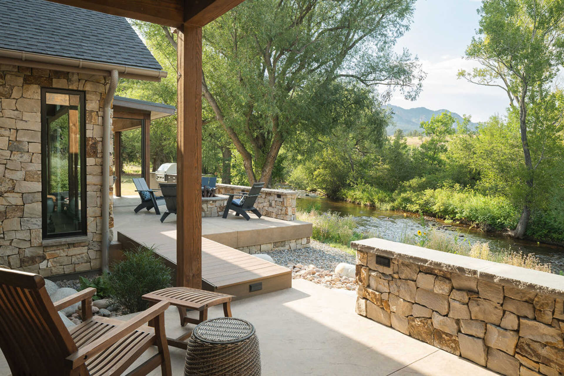 A firepit introduces an additional layer of warmth and becomes a natural gathering point, and connects to other outdoor spaces, including a small beach area by the creek.