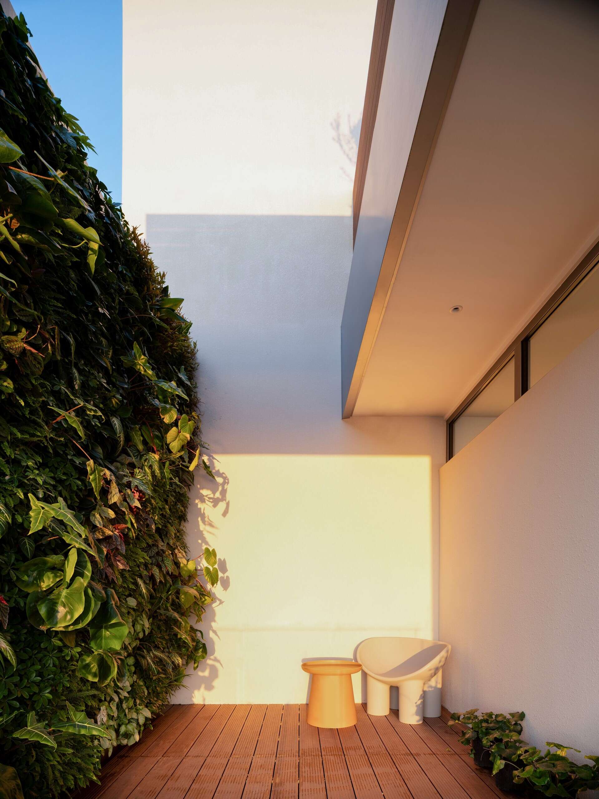 Positioned at the top of the house, this lounge and deck captures coastal views while creating a quiet shared space for parents and children.