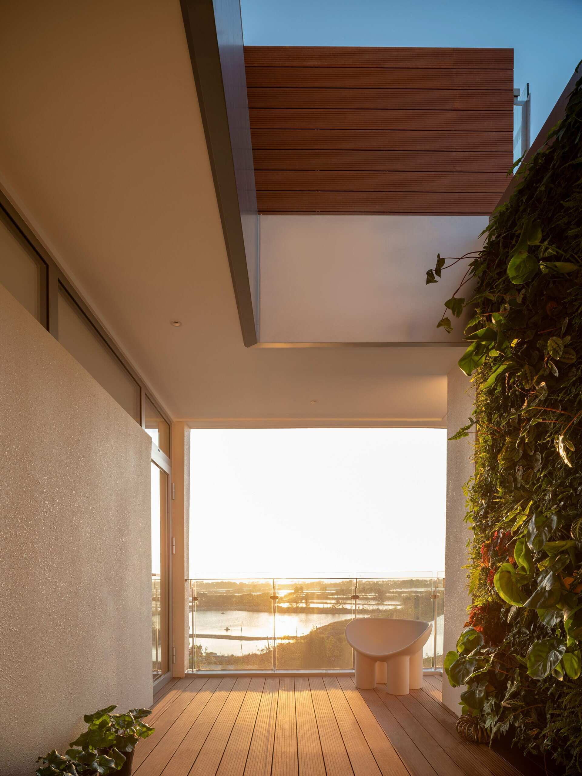 Positioned at the top of the house, this lounge and deck captures coastal views while creating a quiet shared space for parents and children.