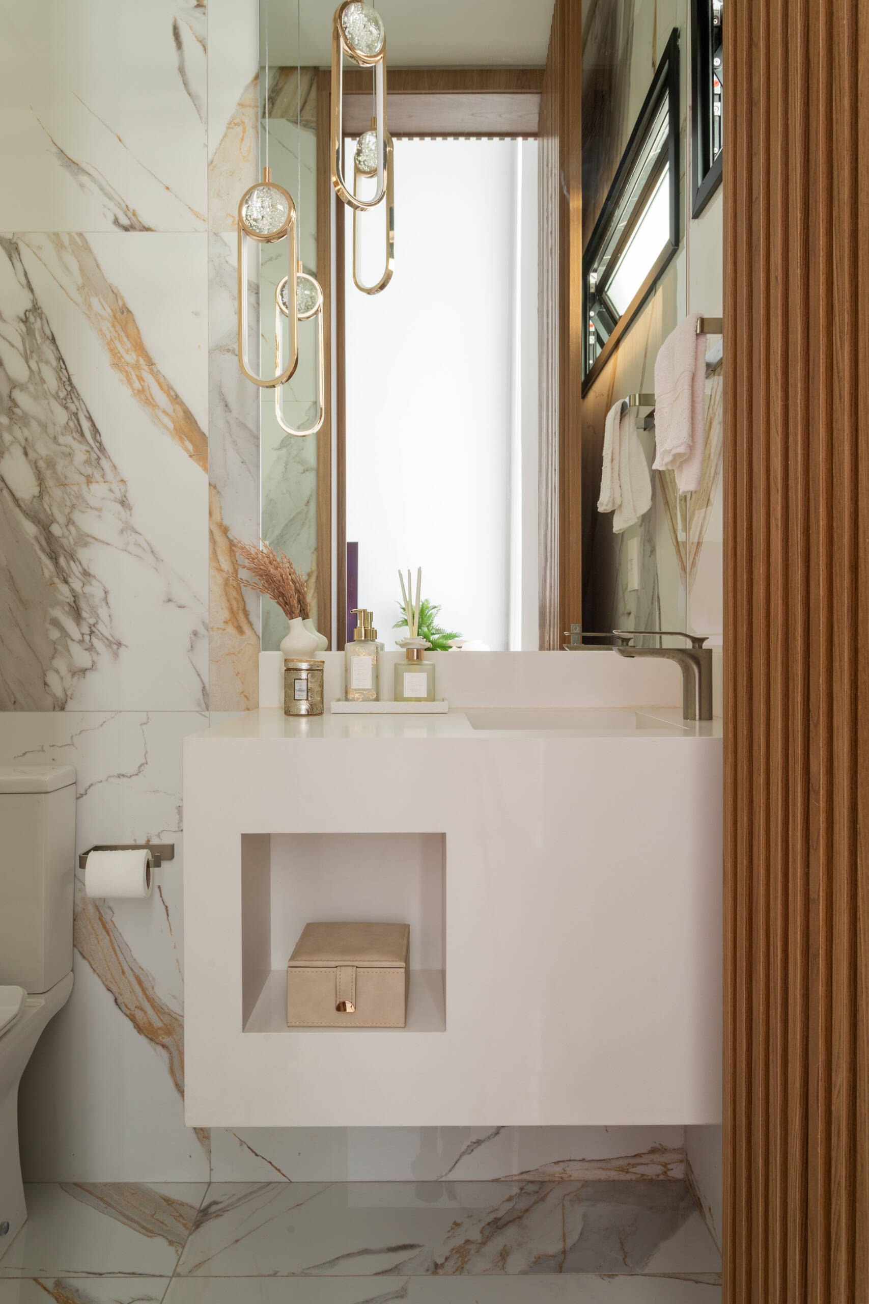This sculptural powder room in Casa R|L features dramatic textures, minimalist finishes, and bold contemporary design details.