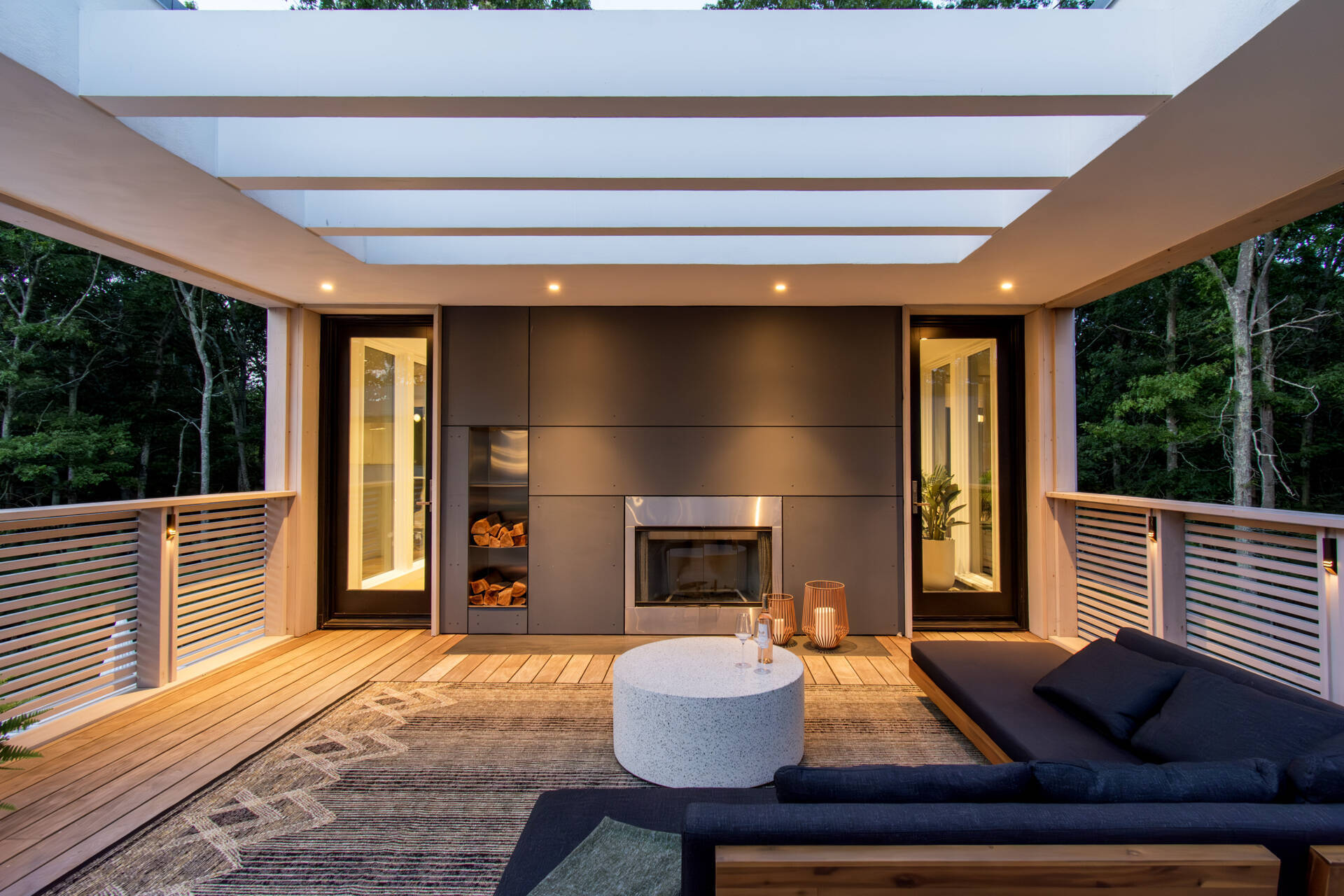 A rooftop terrace surrounded by tree canopy creates a peaceful outdoor space above the forest.