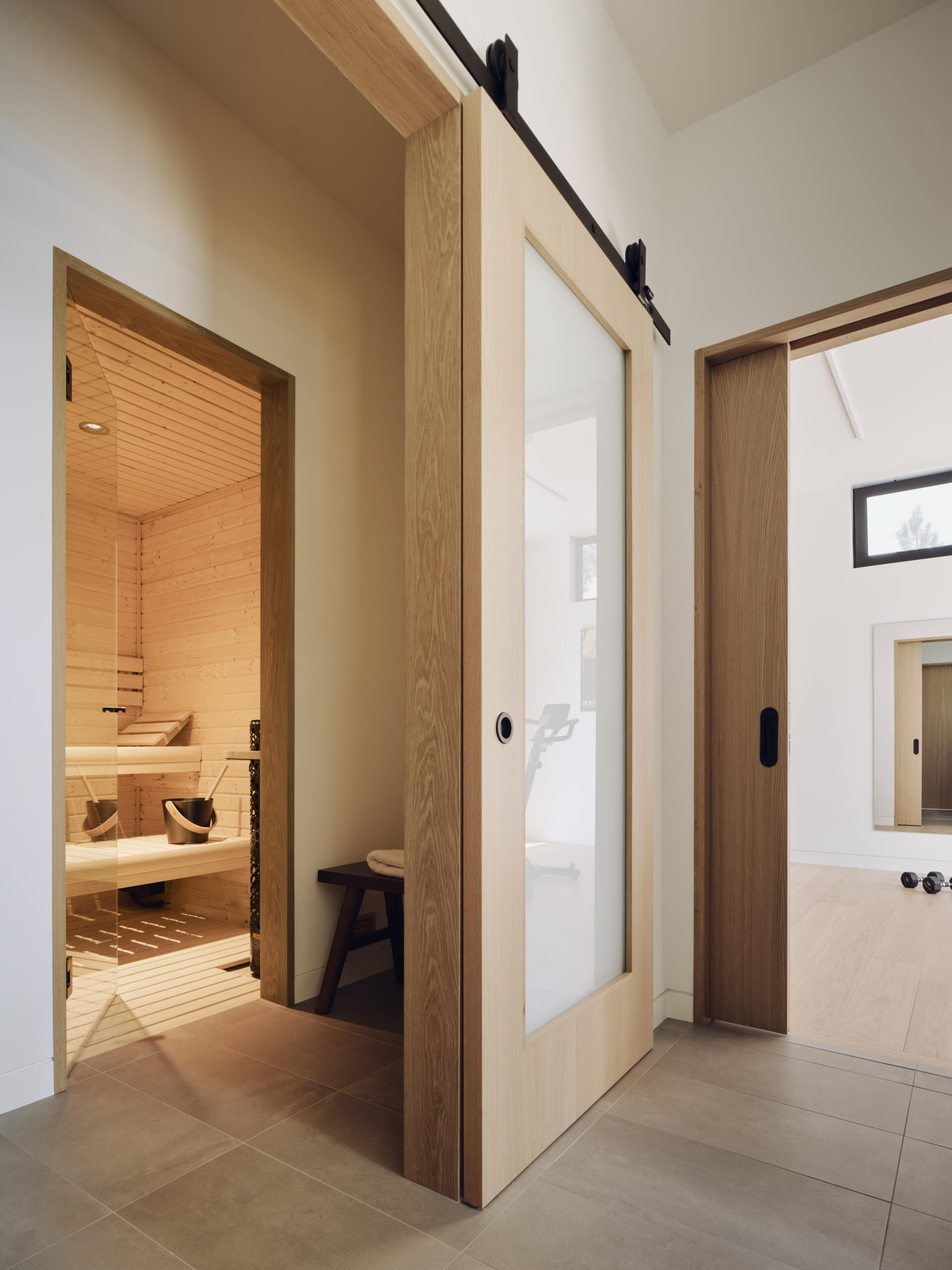 Warm wood finishes give this minimalist sauna a calming atmosphere that perfectly complements the home’s modern design.
