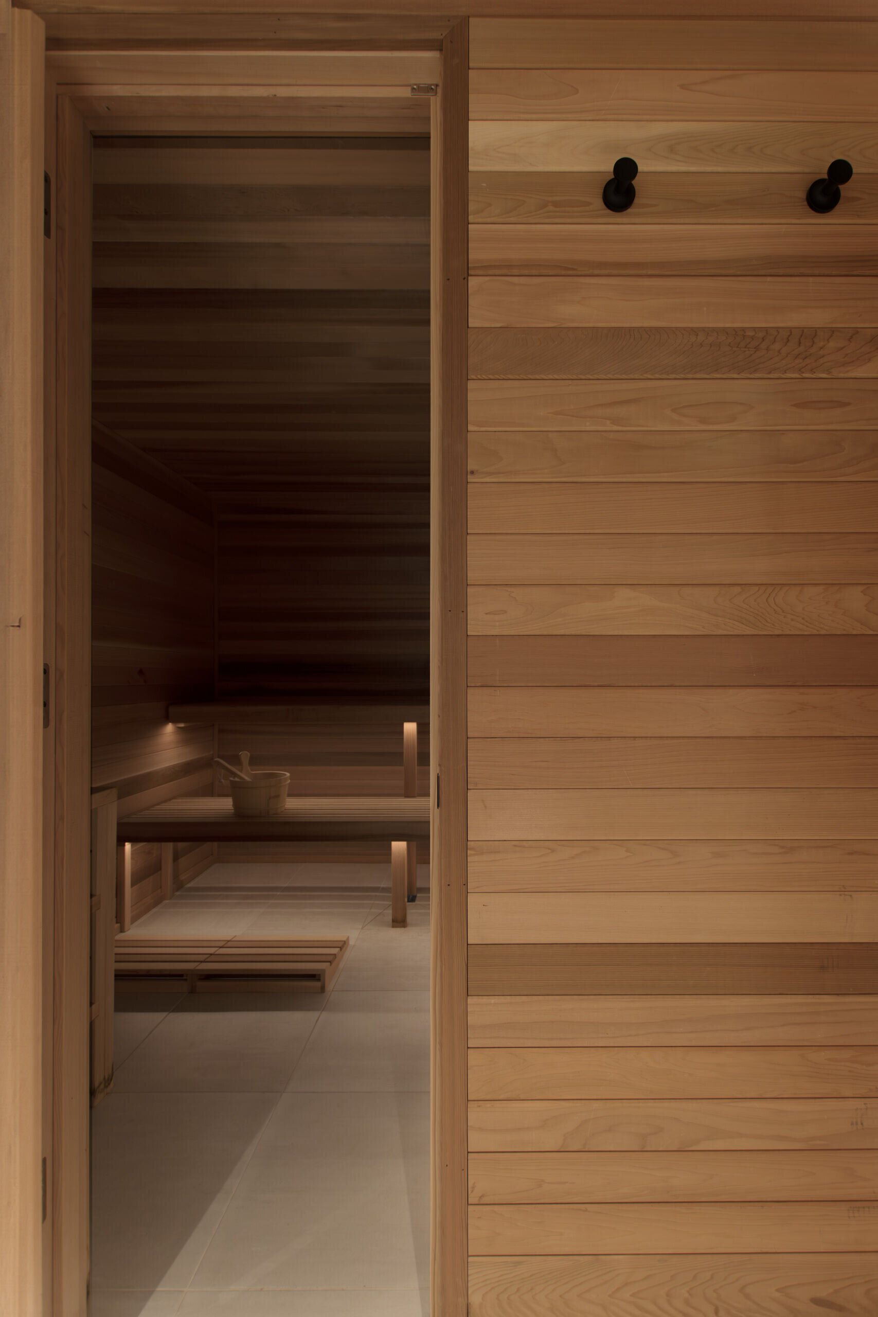 A cedar-lined sauna adds warmth and a spa-inspired atmosphere to the lower level of the home.