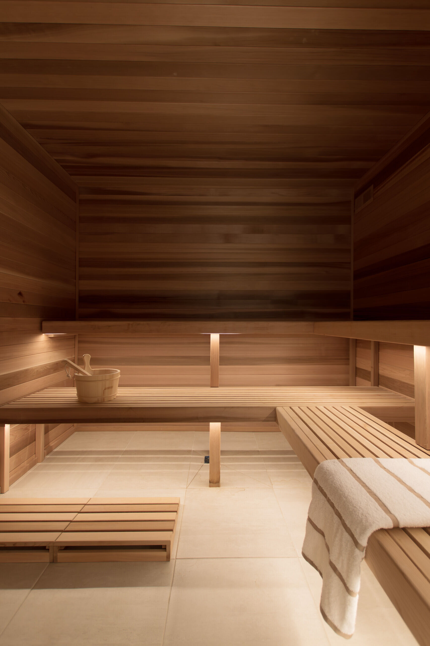 A cedar-lined sauna adds warmth and a spa-inspired atmosphere to the lower level of the home.