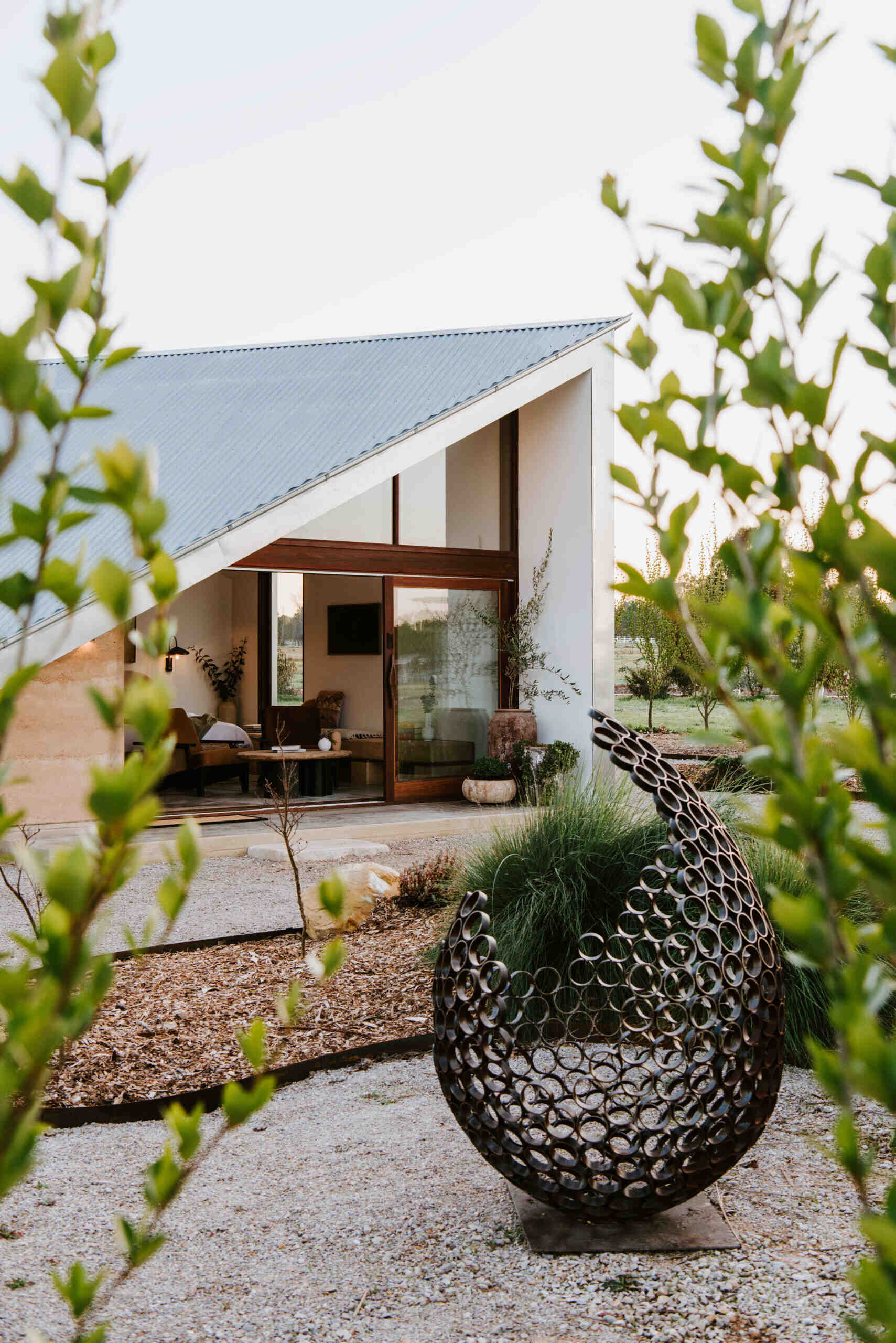 Compact off-grid cabins in Mudgee designed with rammed earth, timber, and a folded roof that reimagines camping through architecture.