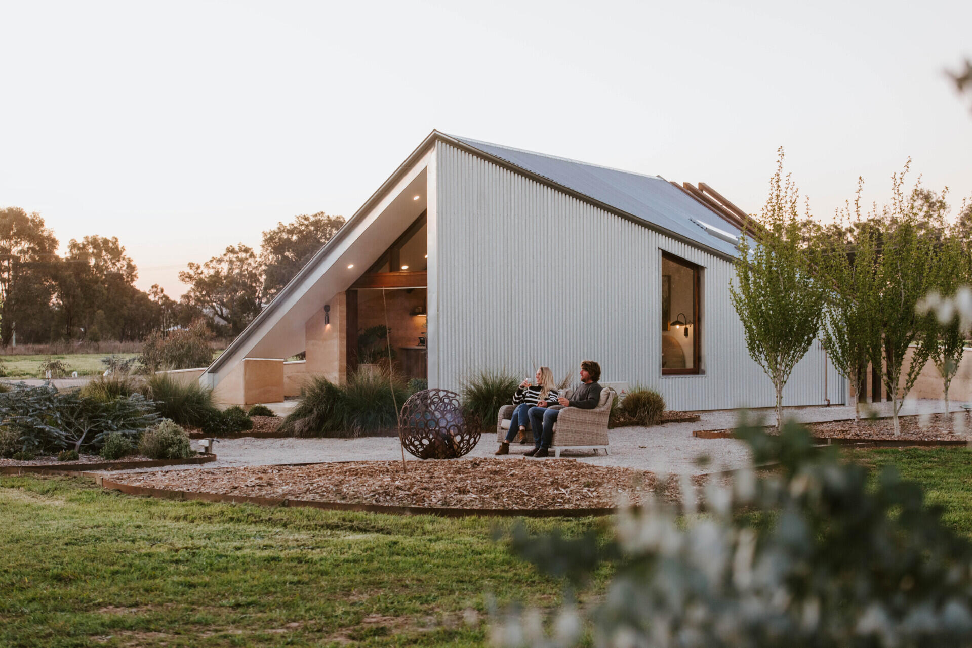 Compact off-grid cabins in Mudgee designed with rammed earth, timber, and a folded roof that reimagines camping through architecture.