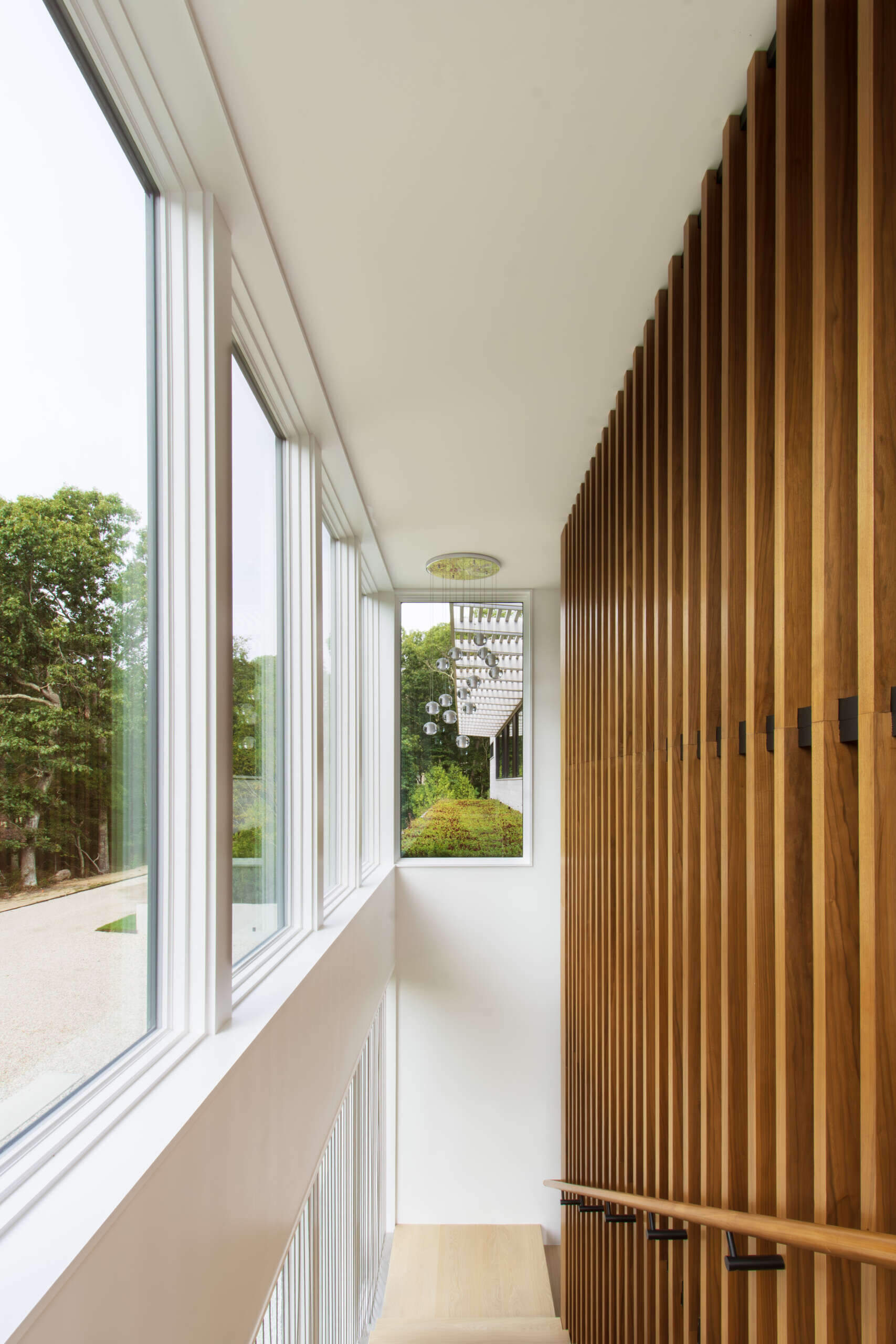 Front and rear staircases acts as both a circulation path and a source of natural light. As sunlight changes through the day, shadows move across the stair walls and flooring, turning the vertical circulation space into one of the most visually dynamic areas of the home.