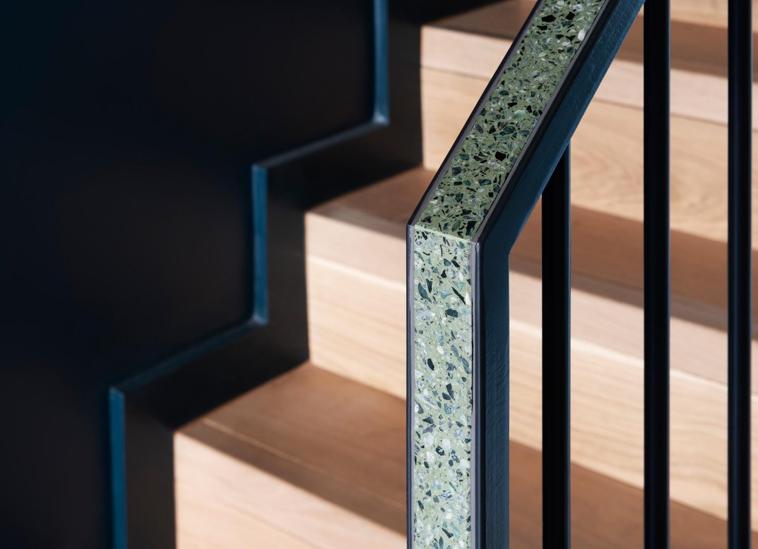 Terrazzo surfaces flow through this London home across floors, stairs, and bathrooms, linking every room with texture and graphic detail.