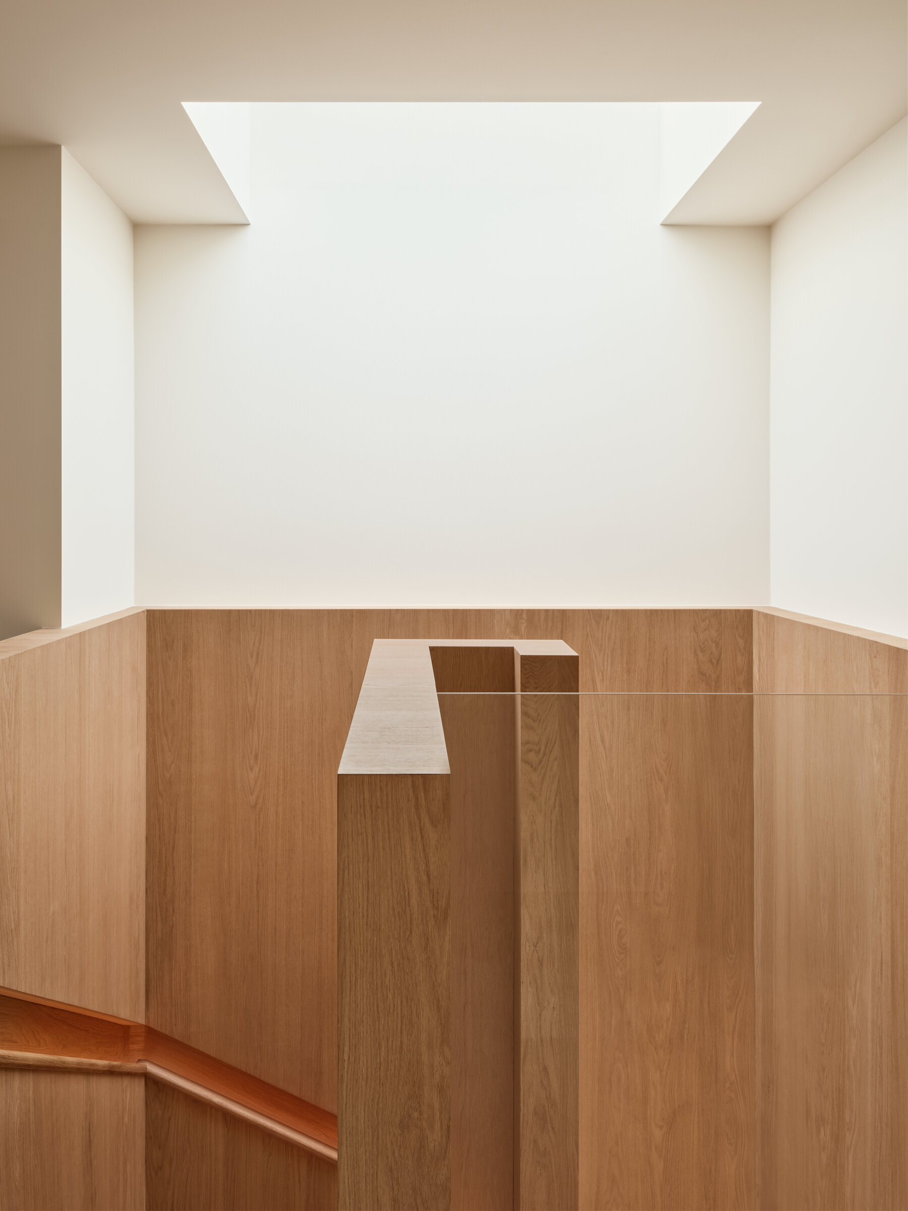 A skylight floods this sculptural staircase with natural light, creating one of the most striking architectural moments in the home.