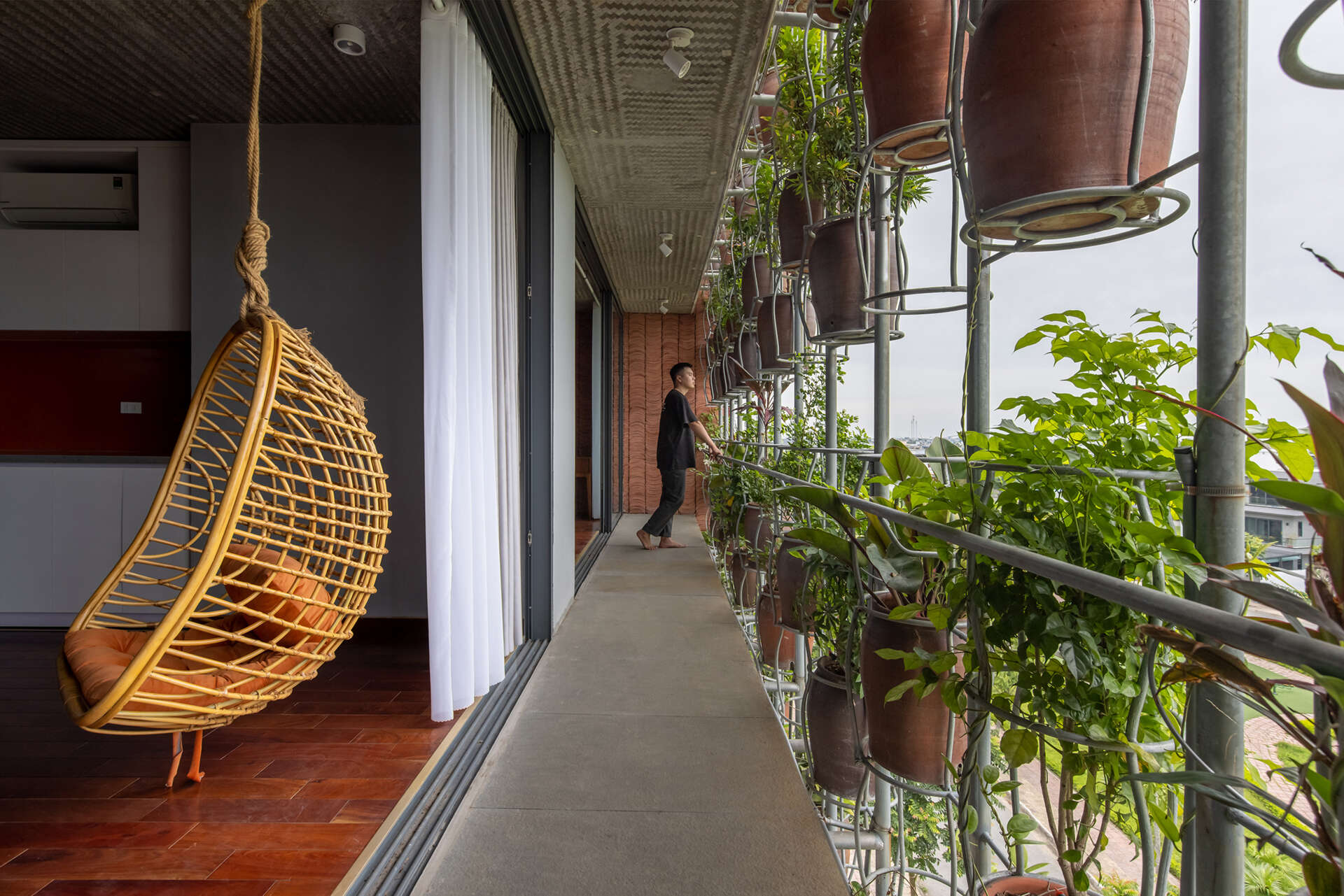 From inside, the planted facade transforms into a soft green filter that changes throughout the day.