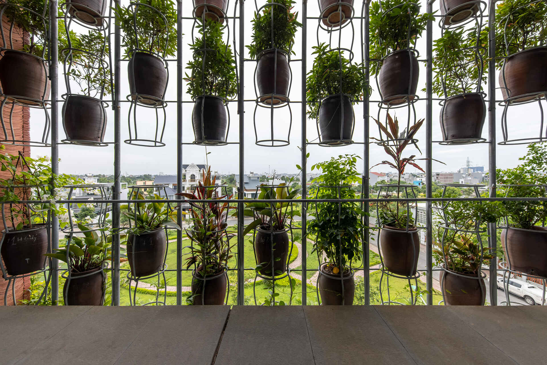 From inside, the planted facade transforms into a soft green filter that changes throughout the day.