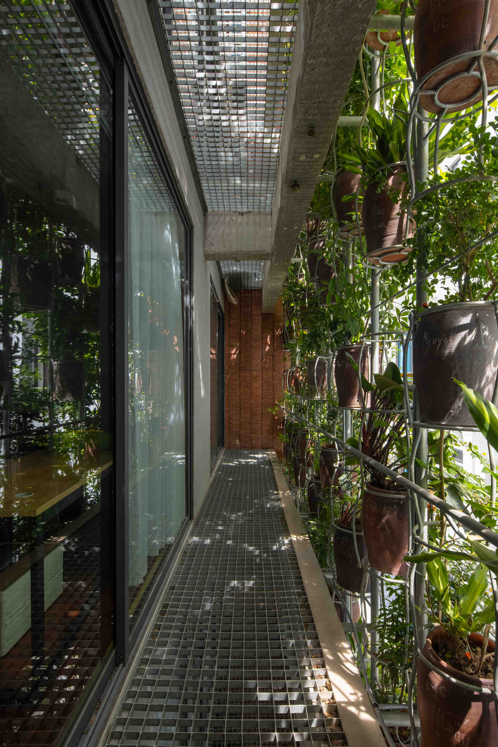 From inside, the planted facade transforms into a soft green filter that changes throughout the day.