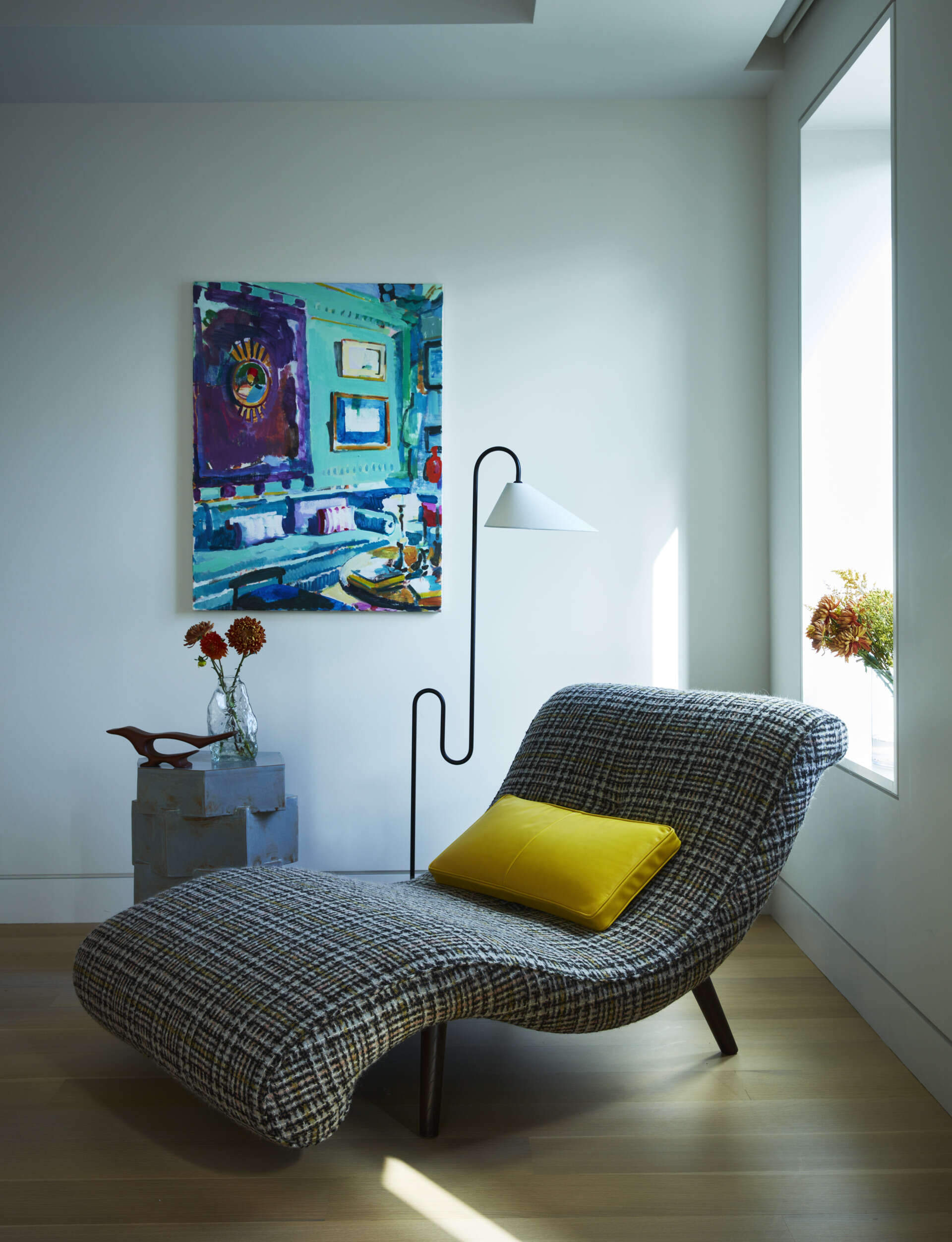 Mohair textures, vintage furniture, and sculptural lighting create a warm and elegant primary bedroom.