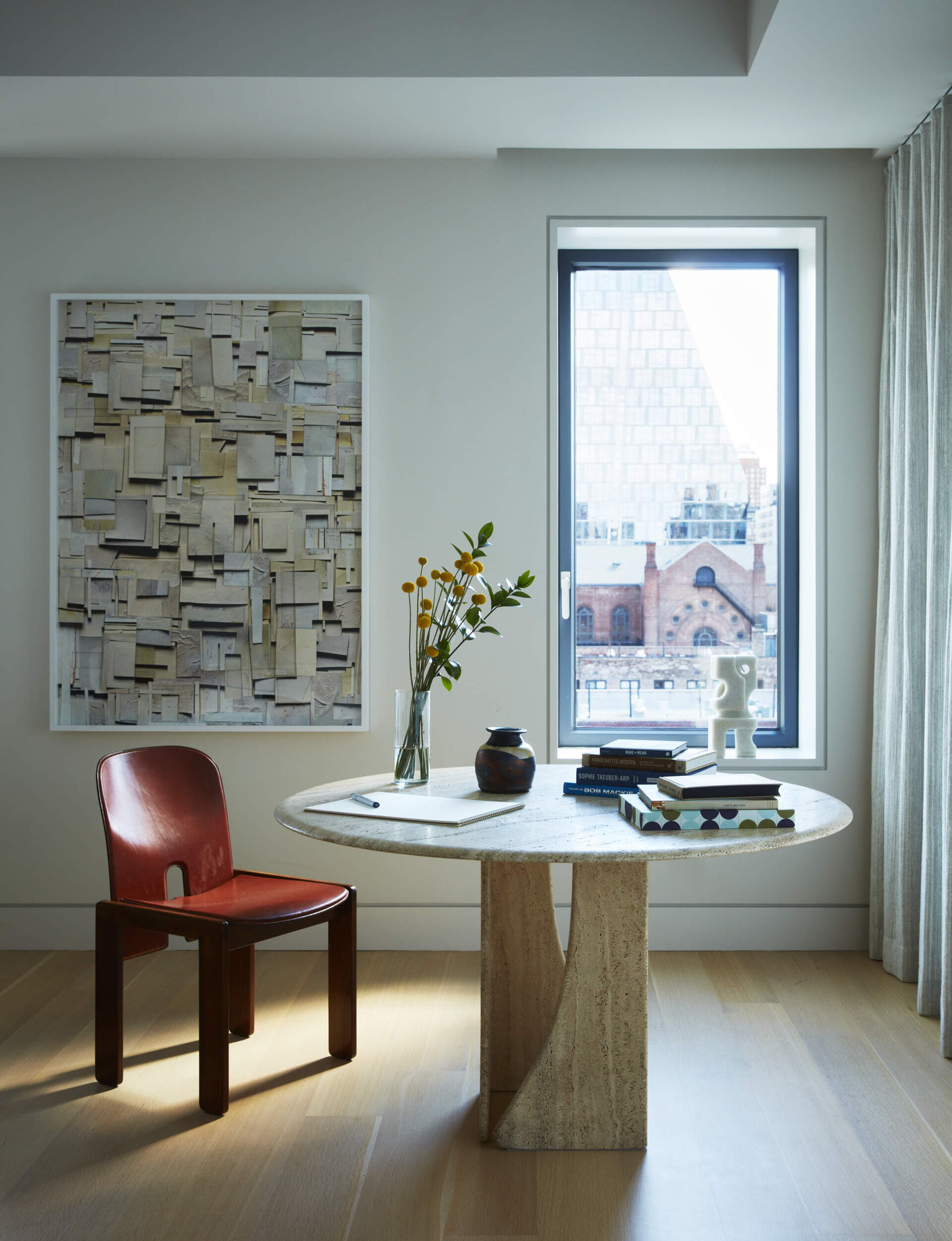 Mohair textures, vintage furniture, and sculptural lighting create a warm and elegant primary bedroom.