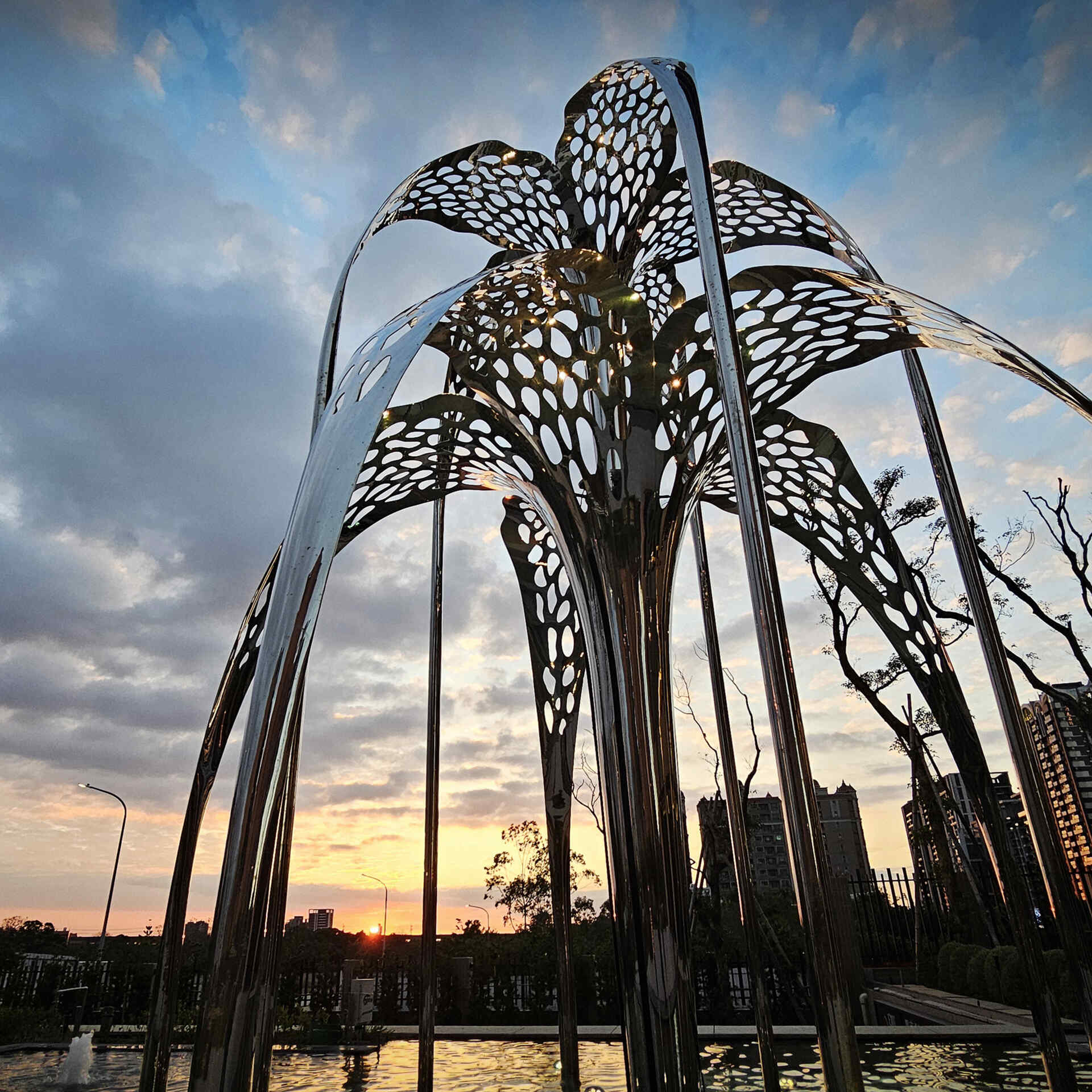 The conceptual inspiration derives from the dual imagery of a fountain and a blooming flower. This biomorphic sculpture, a harmonious fusion of natural forms and advanced material science, serves as a dynamic focal point in its environment.