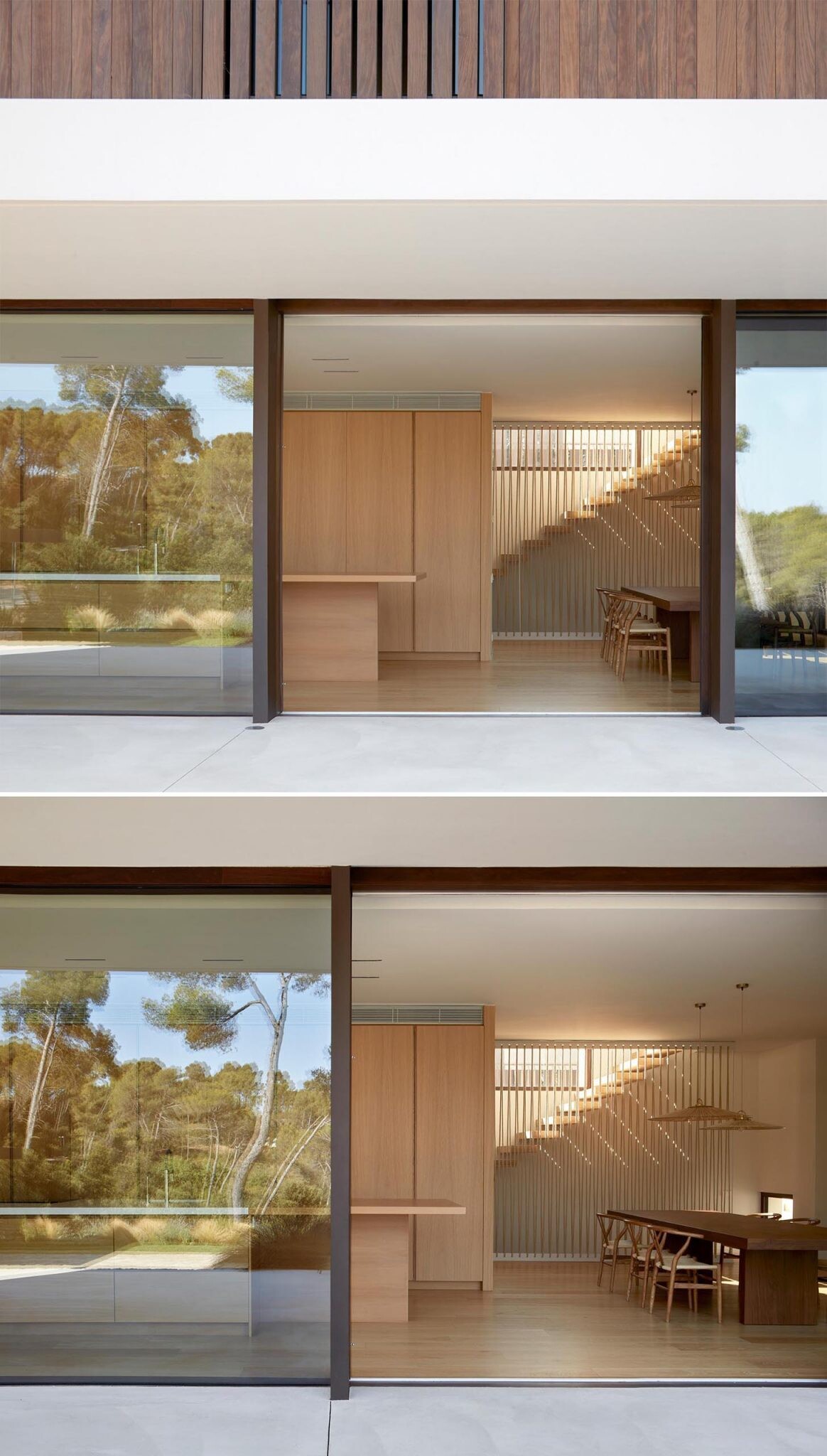 Warm wood interiors, a double-height living room, and huge forest-facing windows define this modern home near Barcelona.