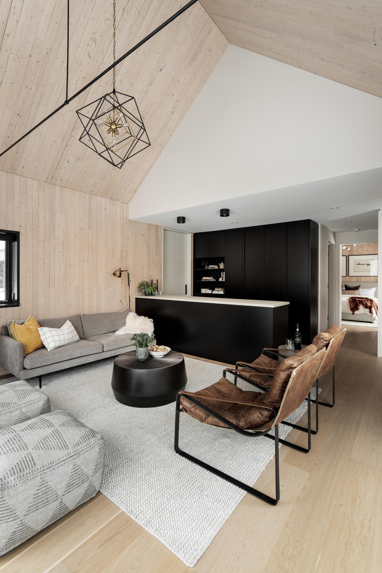 A modern kitchenette with black cabinets.