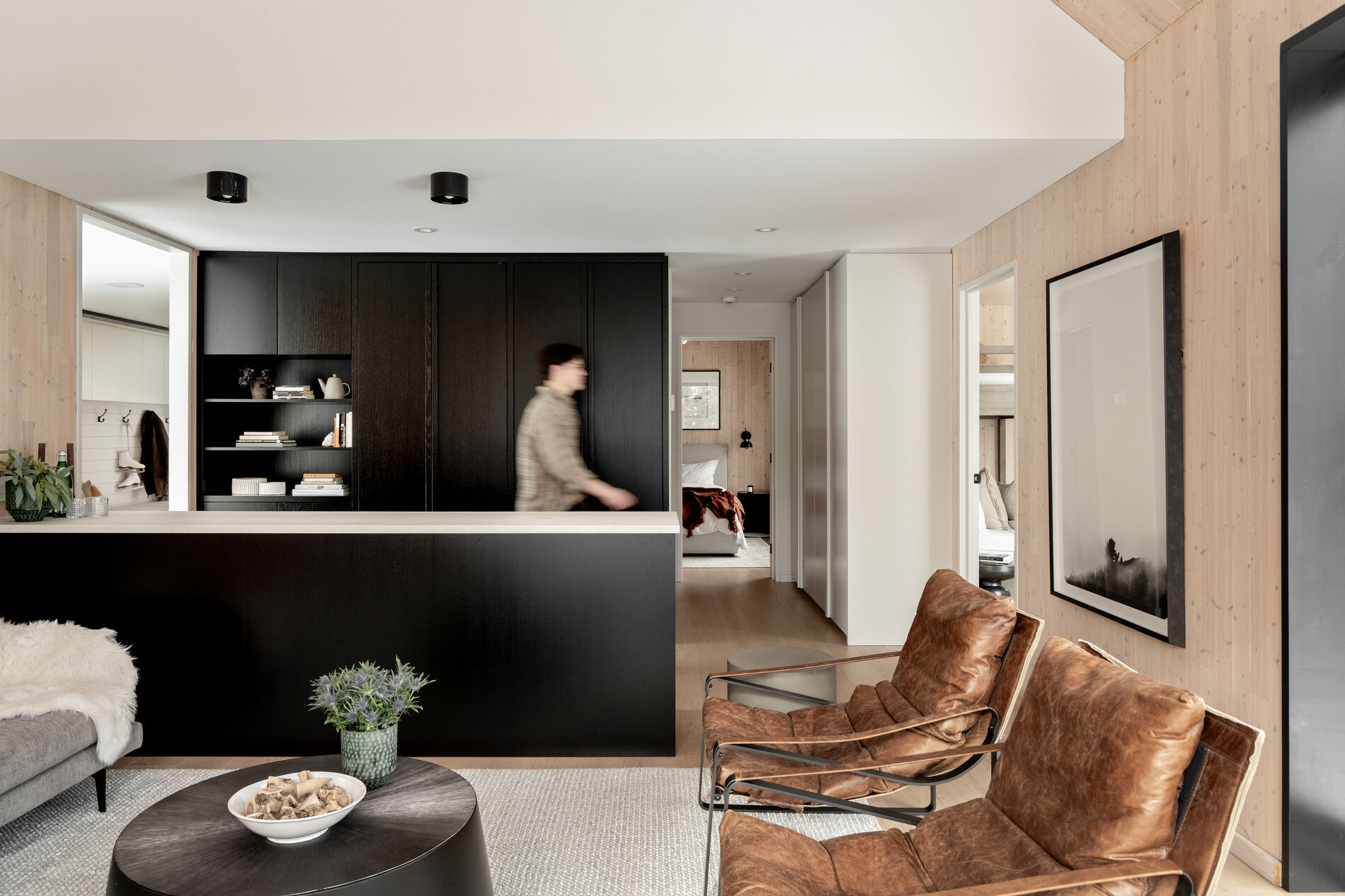 A modern kitchenette with black cabinets.