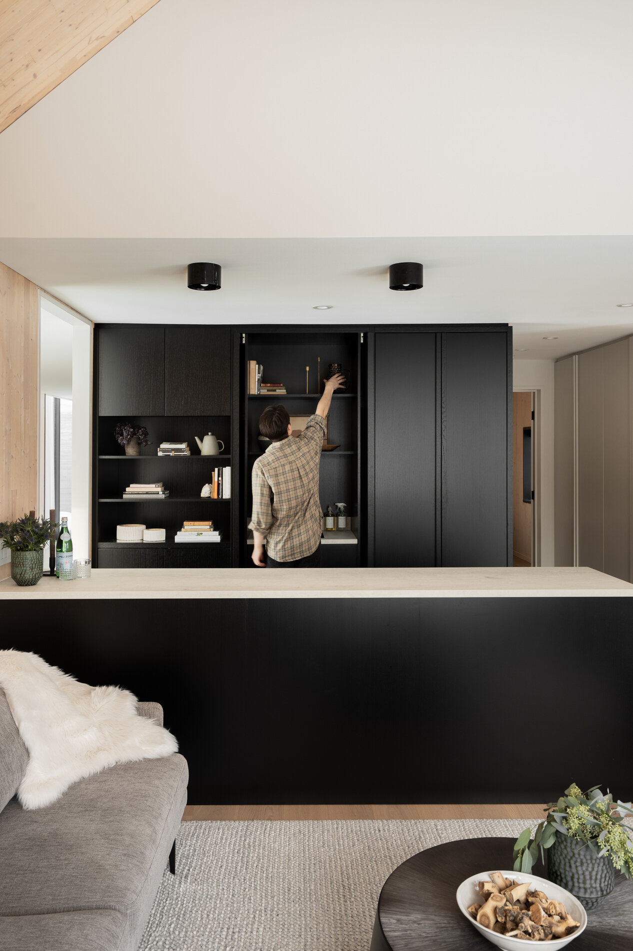 A modern kitchenette with black cabinets.