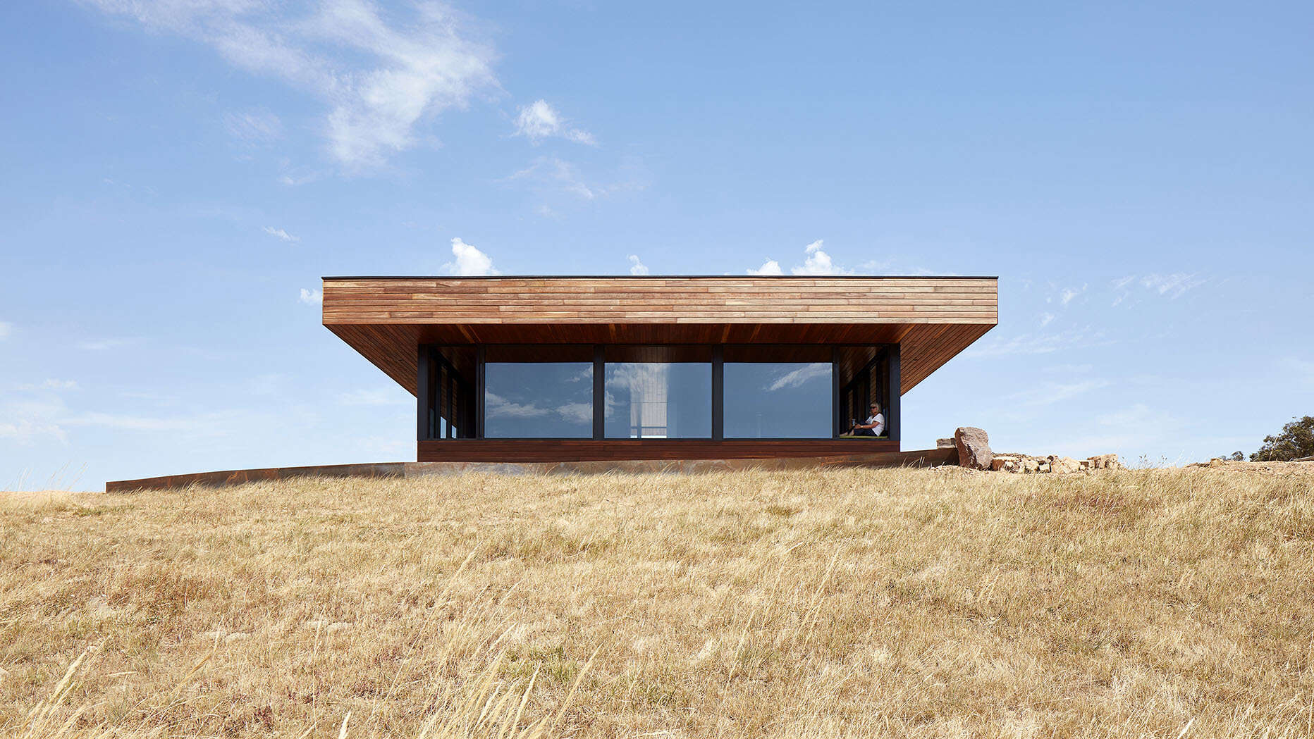 An off-grid home designed to produce its own energy, water, and waste systems in a rural setting. Spotted Gum timber cladding creates a durable, fire-resistant exterior that weathers naturally.
