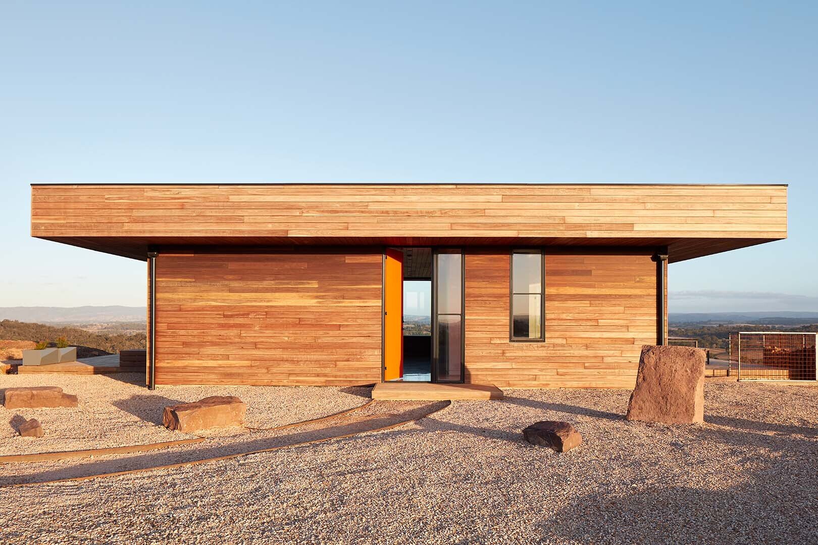 An off-grid home designed to produce its own energy, water, and waste systems in a rural setting. Spotted Gum timber cladding creates a durable, fire-resistant exterior that weathers naturally.