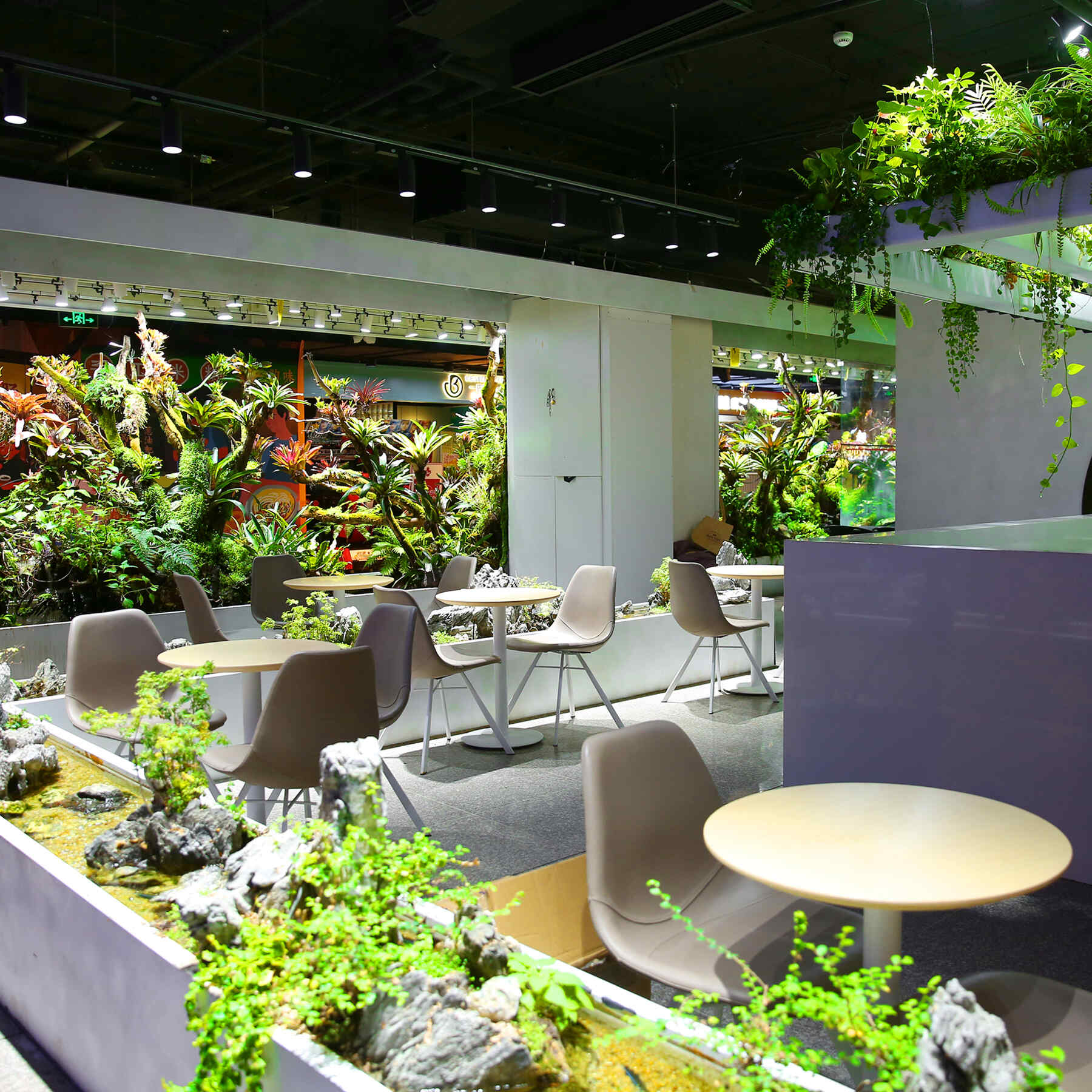 This near-zero-energy smart vertical garden for Tims Cafe in Beijing's underground commercial area merges classical Chinese garden philosophy with modern low-carbon technology.