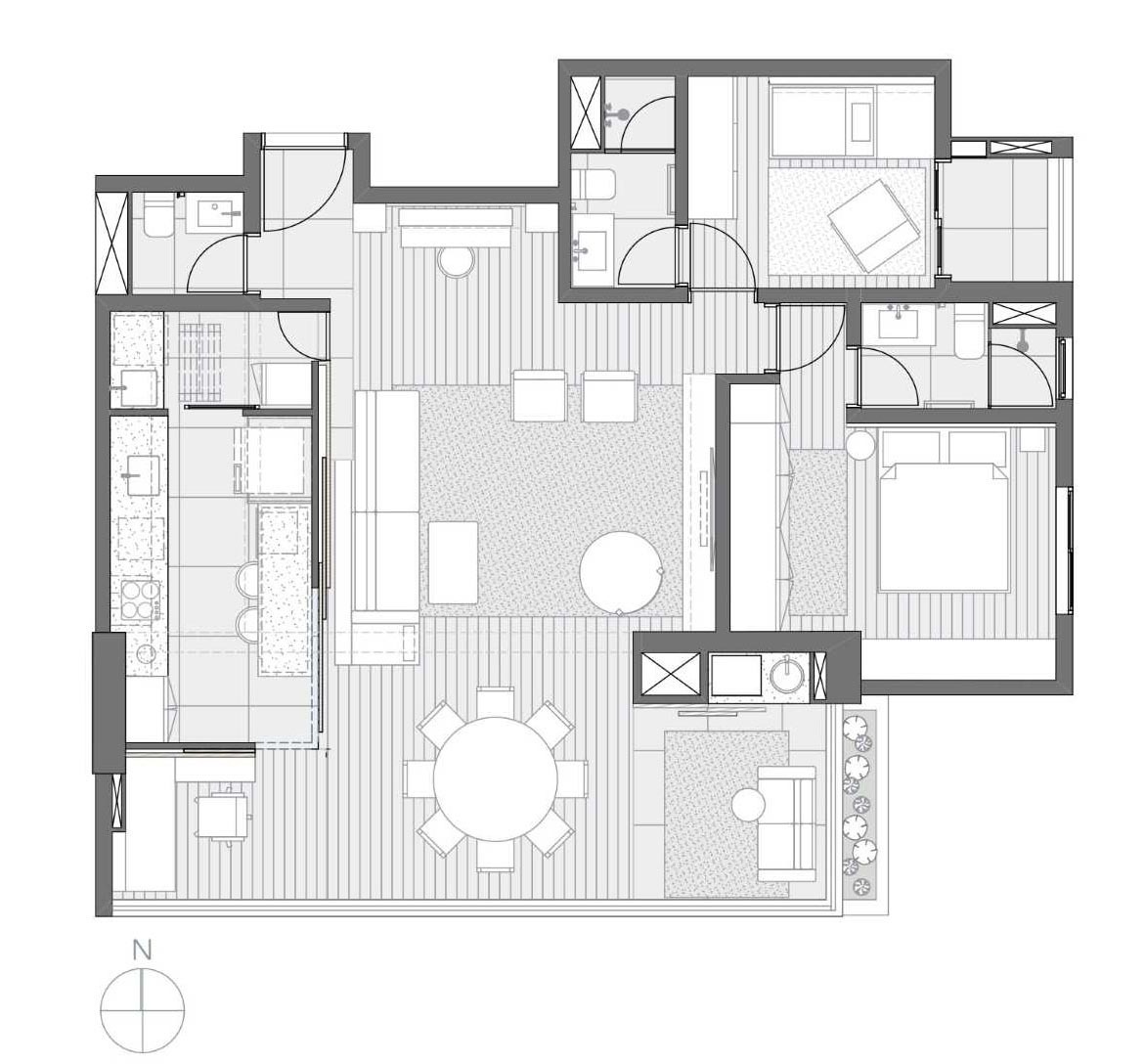 The floor plan reveals how a single feature wall organizes the entire apartment, hiding work and utility spaces while keeping the layout open and bright.
