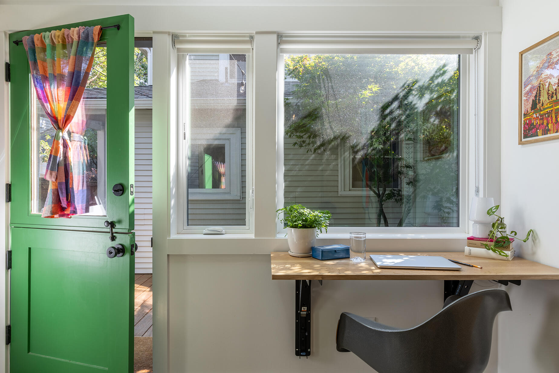A fold-down desk transforms this compact studio from home office to guest suite in seconds, proving that small spaces can still be incredibly versatile.