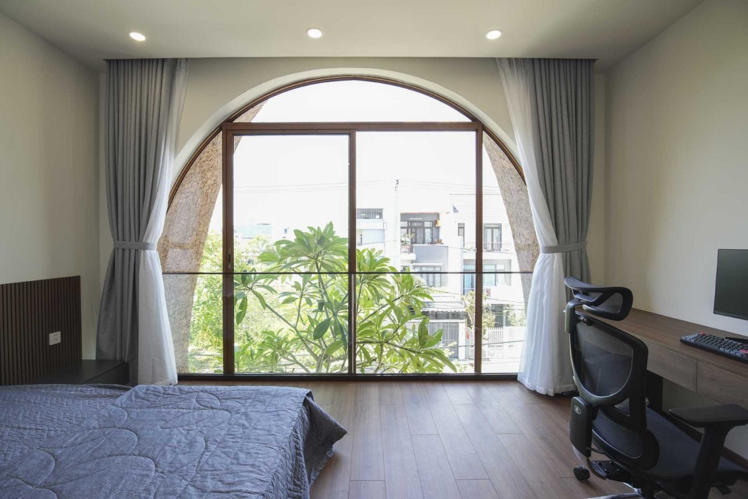 Bridge corridors, timber-framed windows, and views of the dramatic facade make the bedrooms a standout feature of this five-level home.